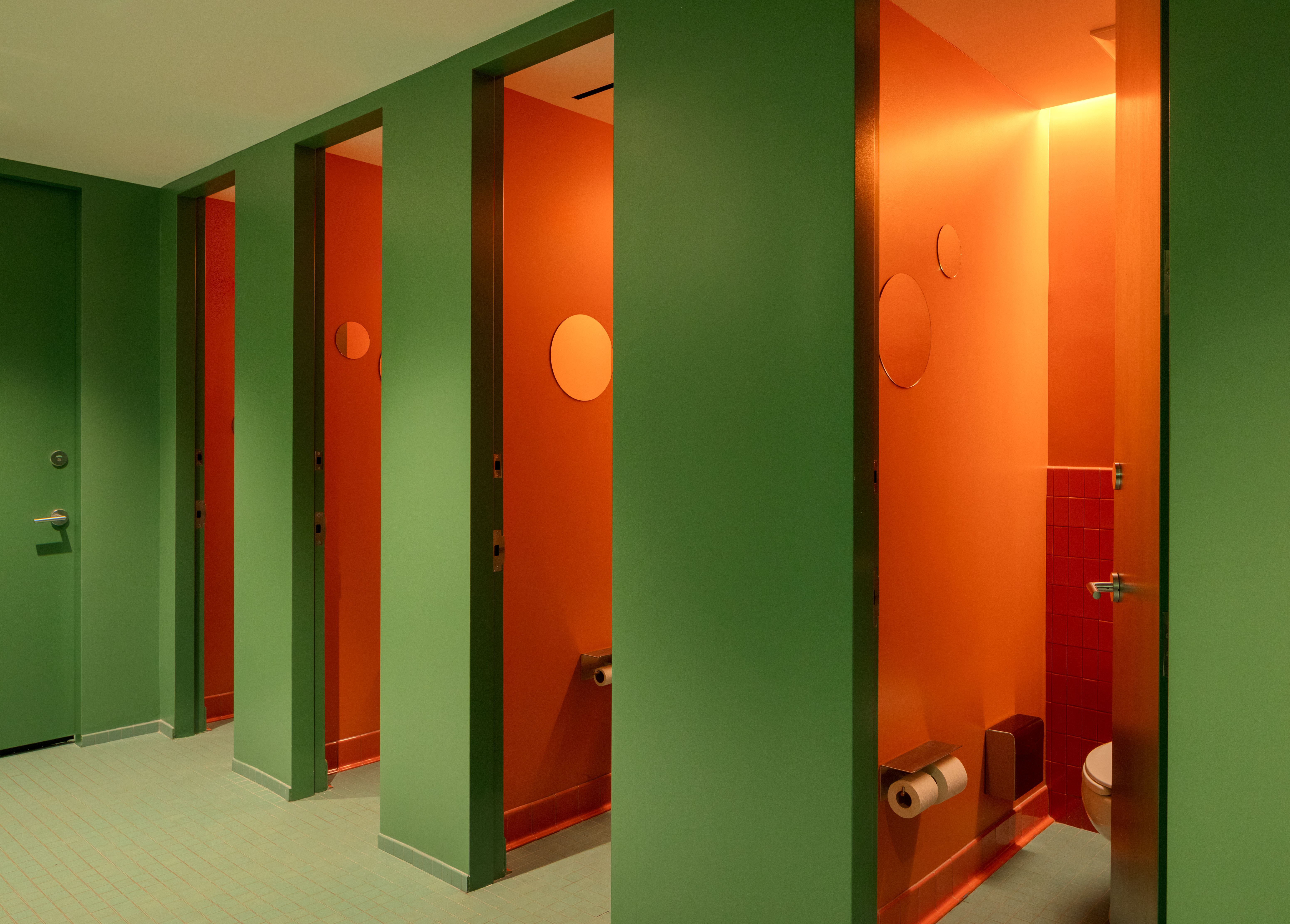 Colorful orange and green restrooms at Snohetta office