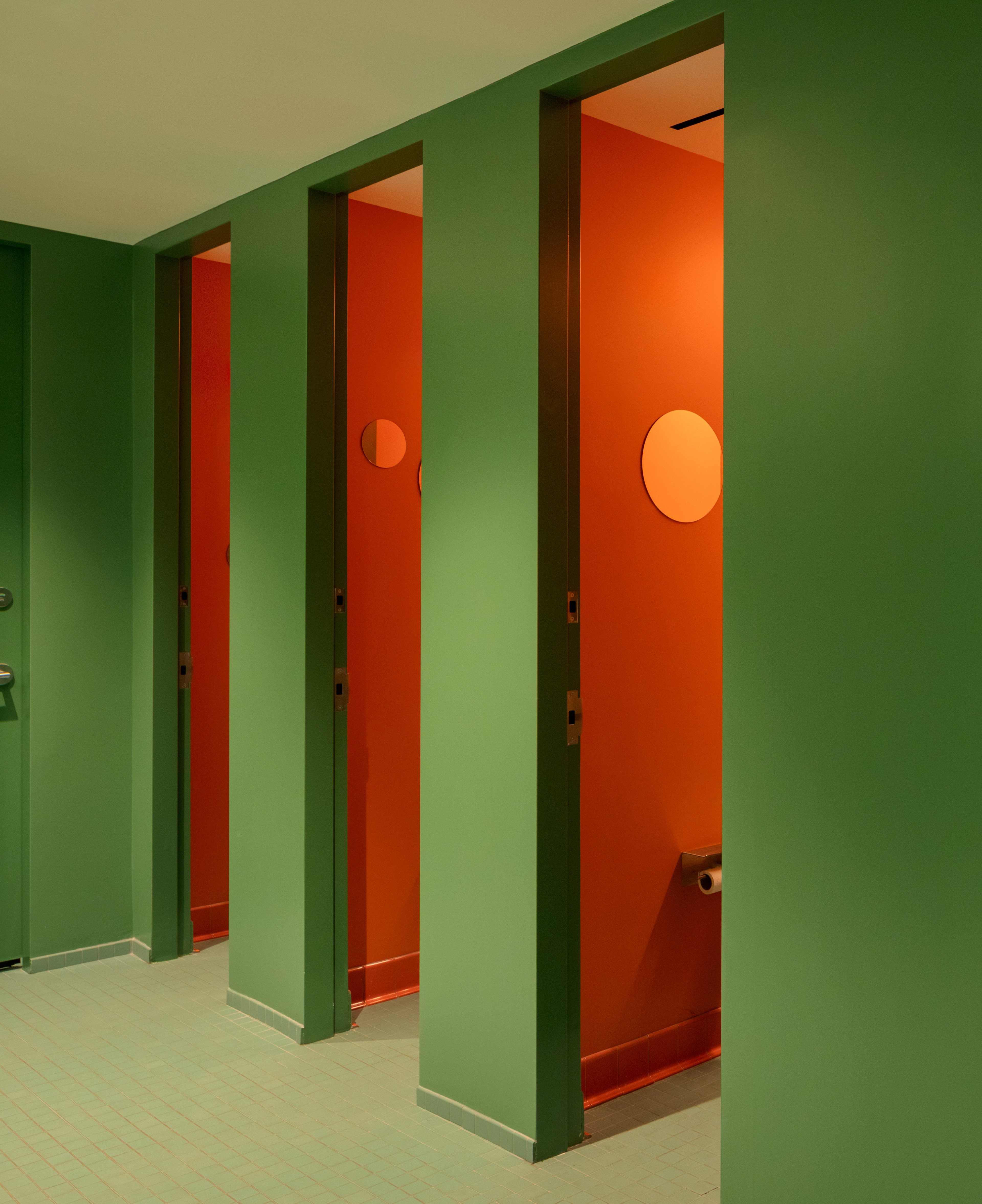 Colorful orange and green restrooms at Snohetta office