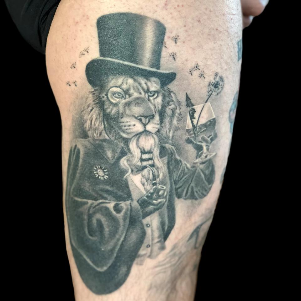 Lion with top-hat tattoo
