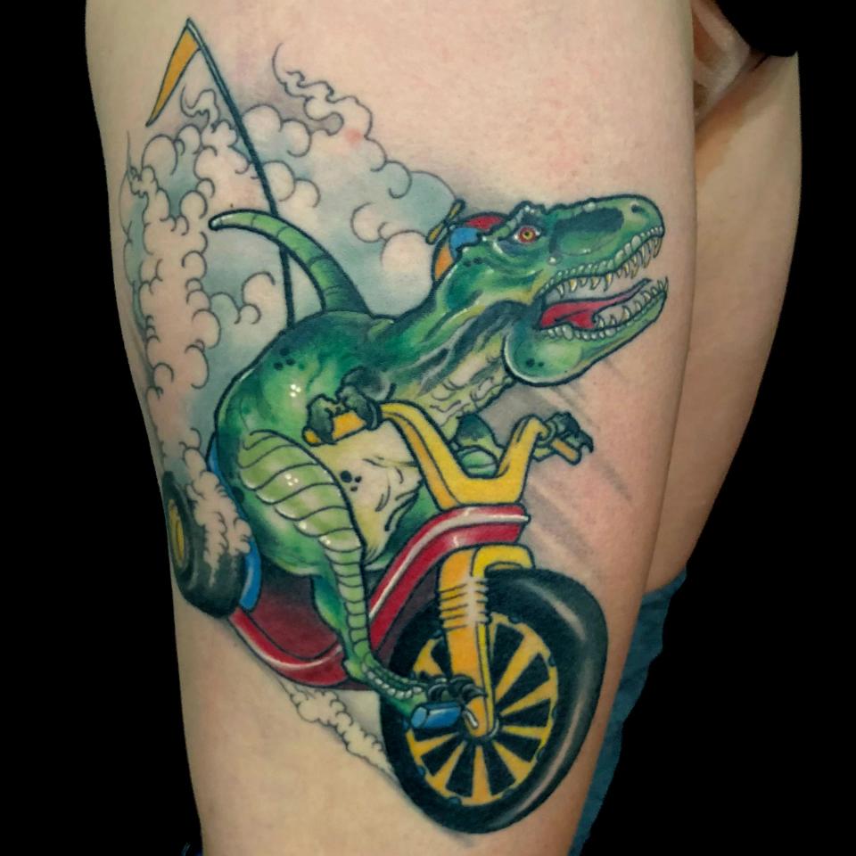 Tyrannosaurus riding big wheel tattoo