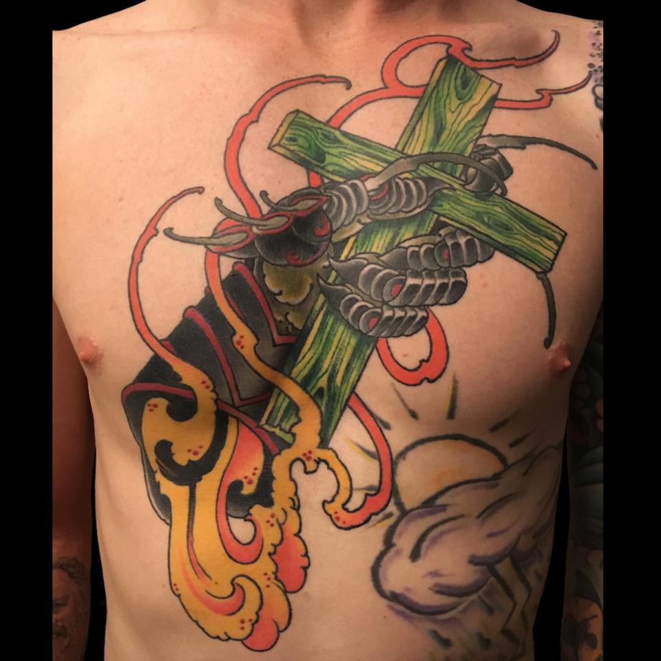 Cross chest piece tattoo