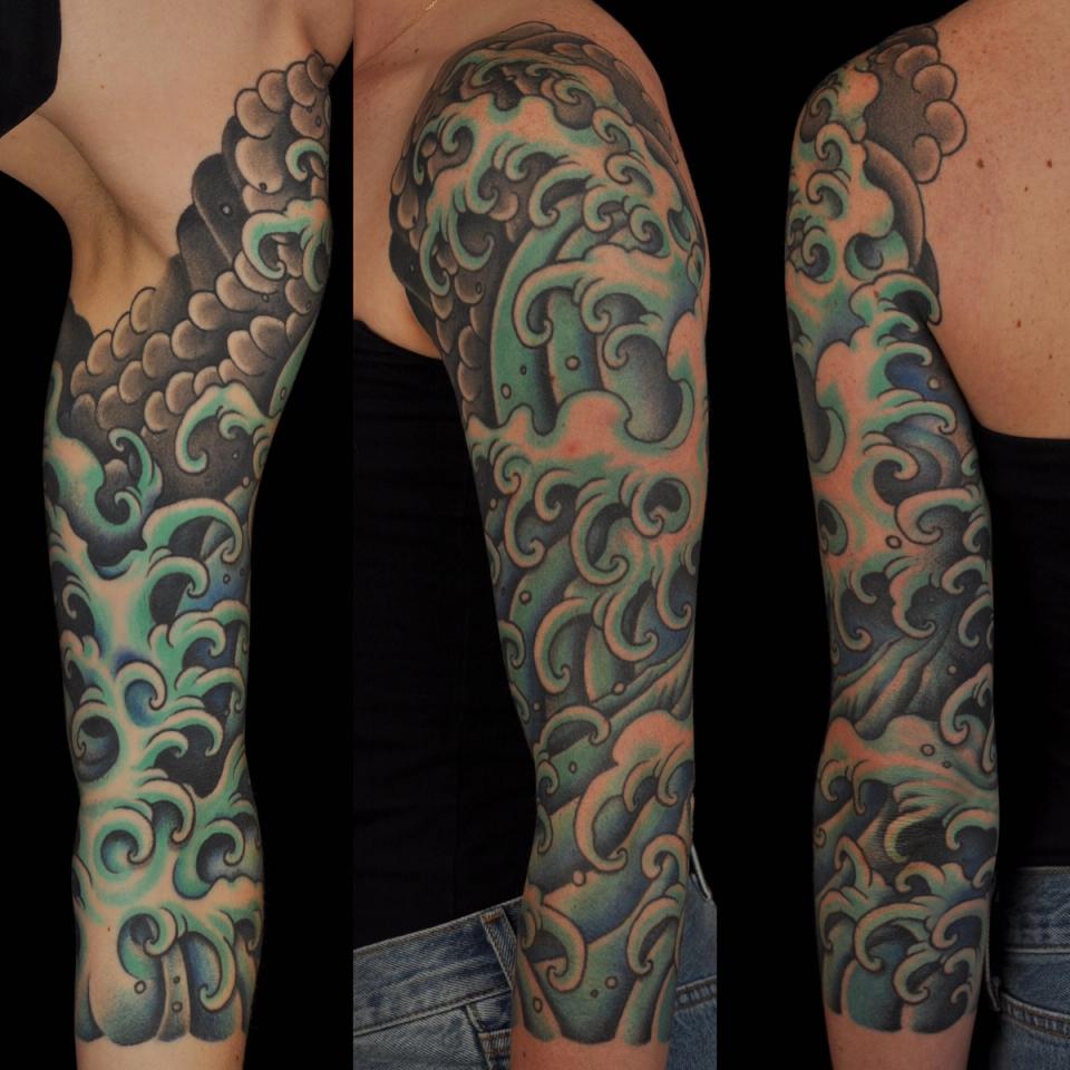 Waves arm sleeve tattoo