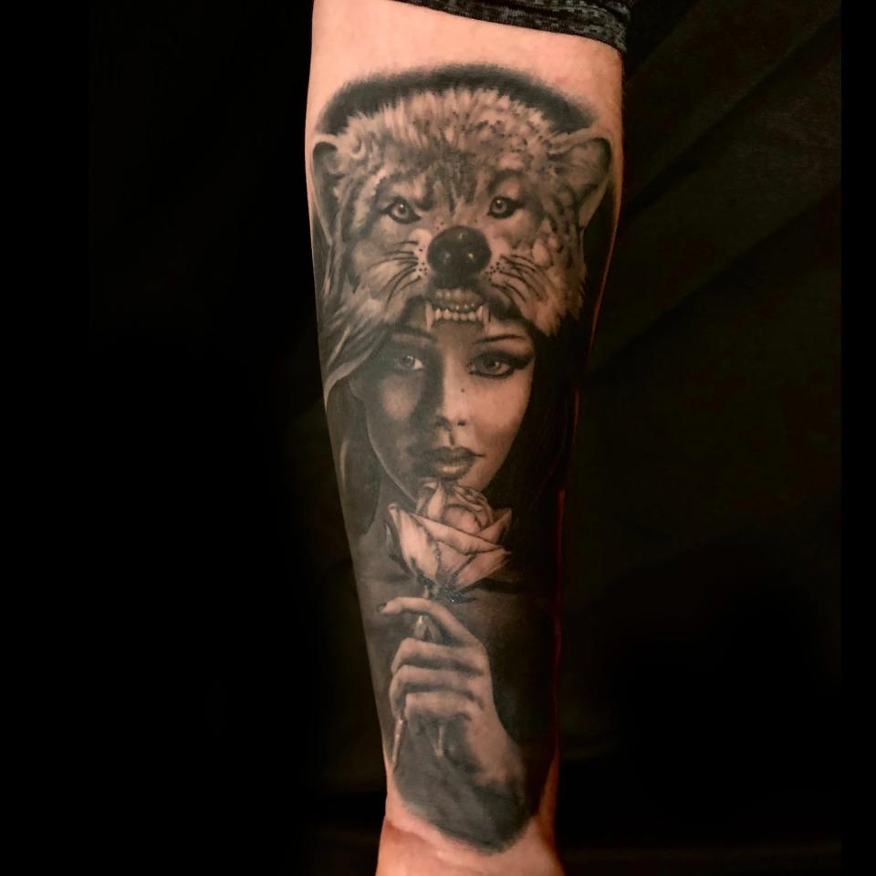 Woman with wolf hat tattoo