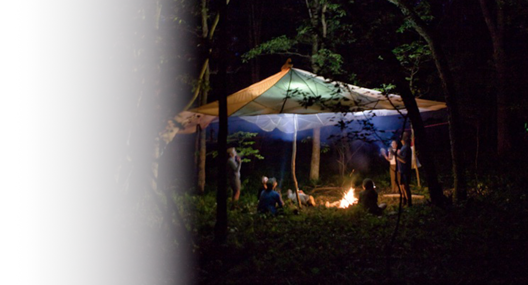 People under a parachute in the dark