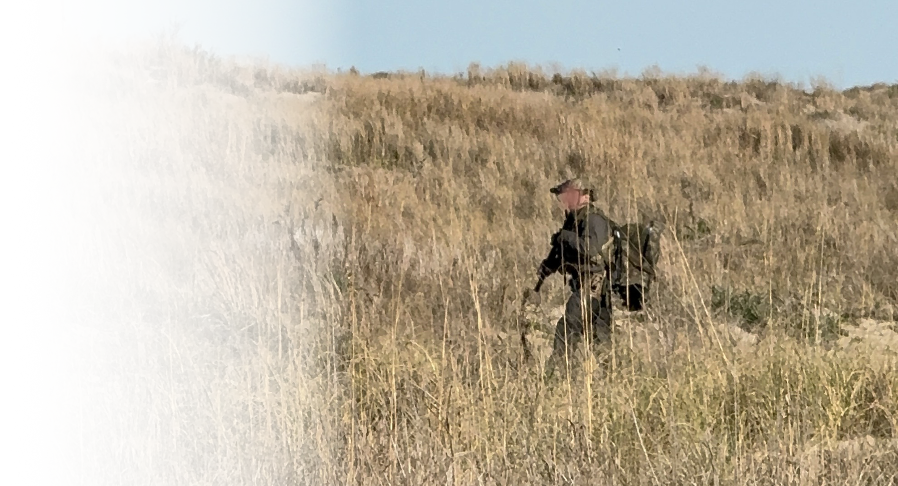 SOF member doing land navigation while crossing field
