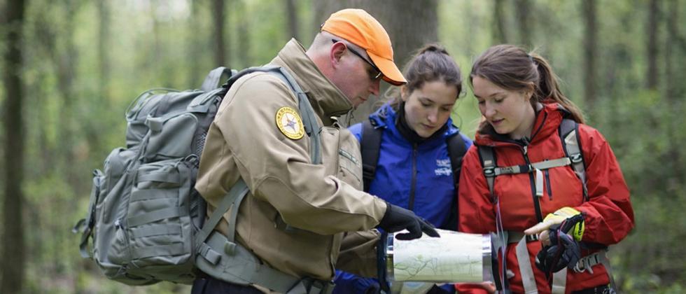 Instructor teaching two clients