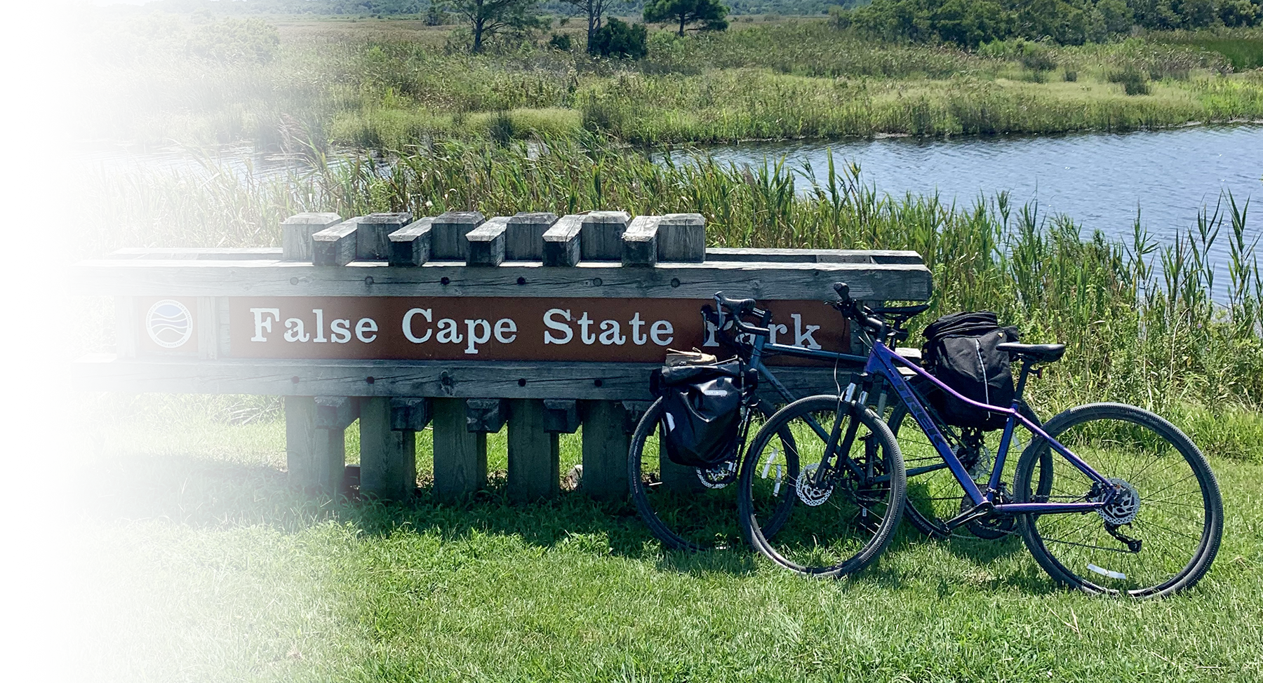Two Bikes leaning against a state park sign