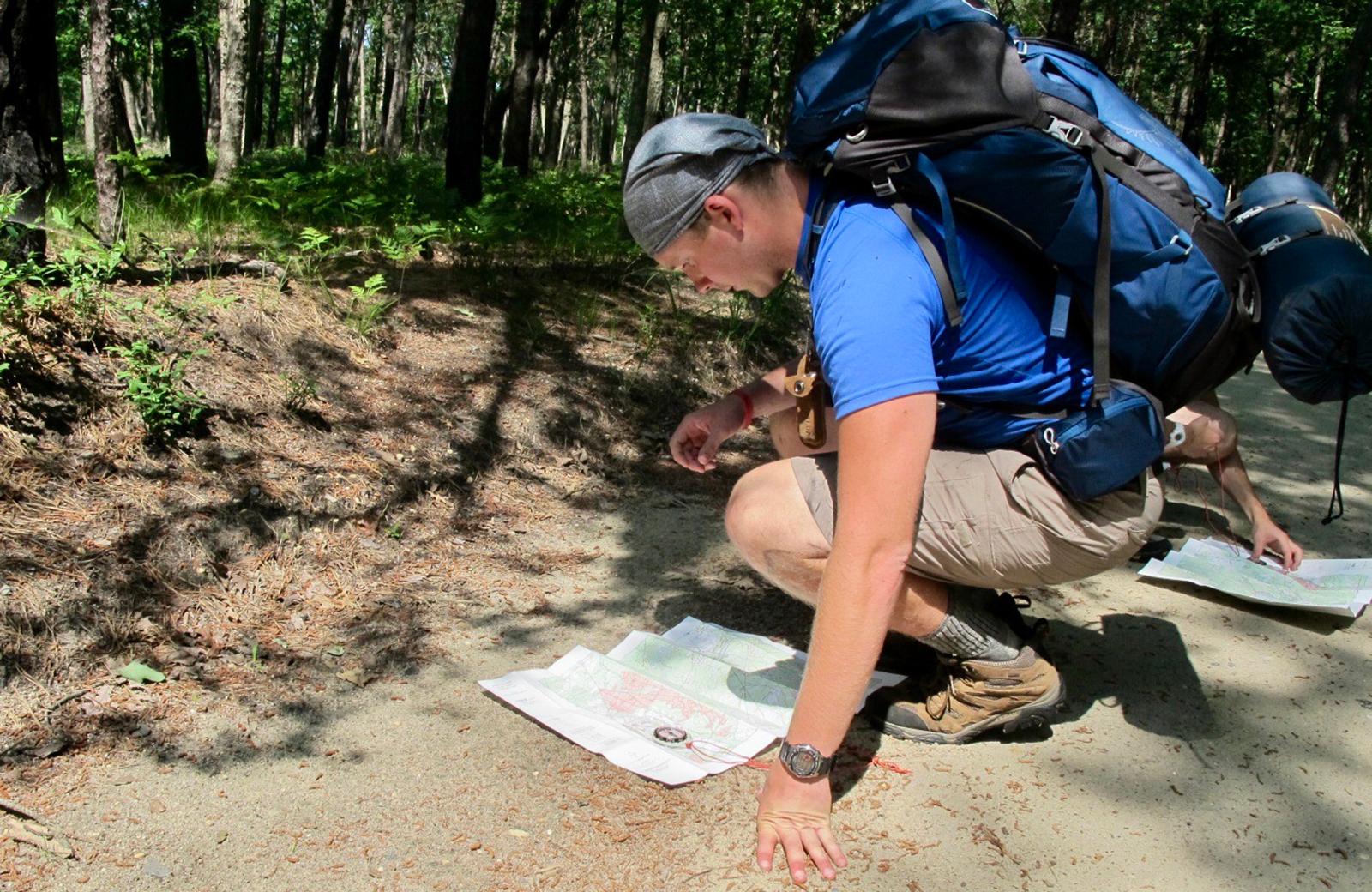 Backpacker reviewing a map