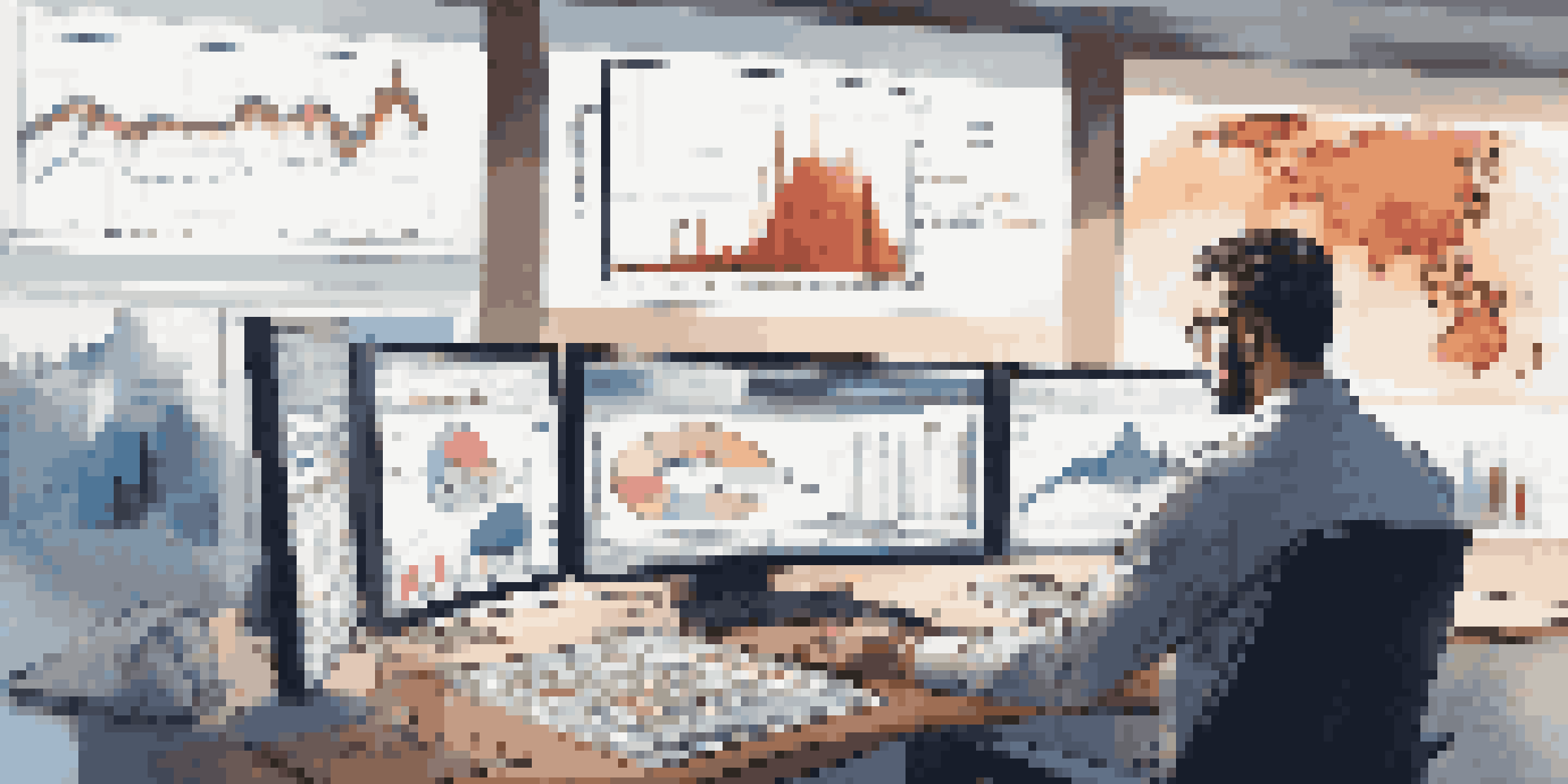 A trader in a modern office analyzing market trends with multiple screens showing graphs and charts.