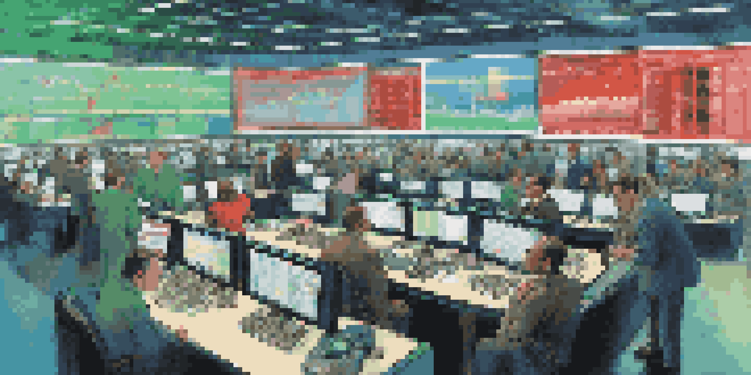 A busy commodity trading floor with traders analyzing data on screens, surrounded by colorful charts and graphs.