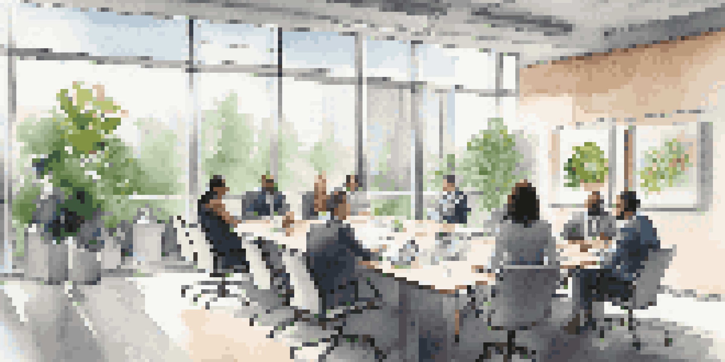 A diverse group of professionals discussing in a modern office with large windows and contemporary decor.