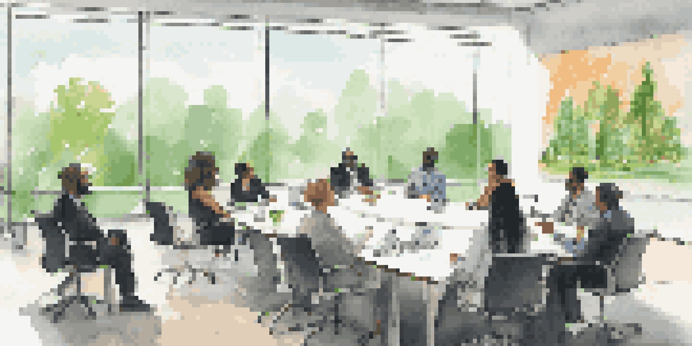 A diverse group of investors discussing shareholder activism in a bright conference room with large windows and a view of a green park.