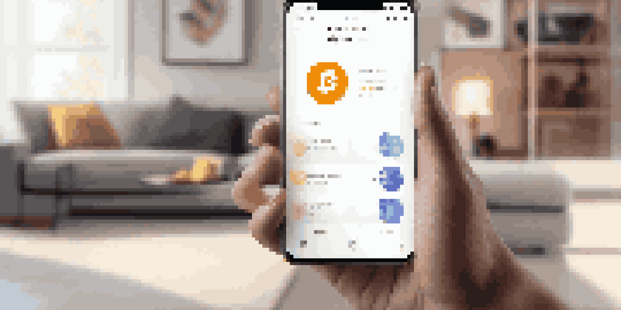 Close-up of a hand holding a smartphone with a cryptocurrency wallet app in a modern living room.