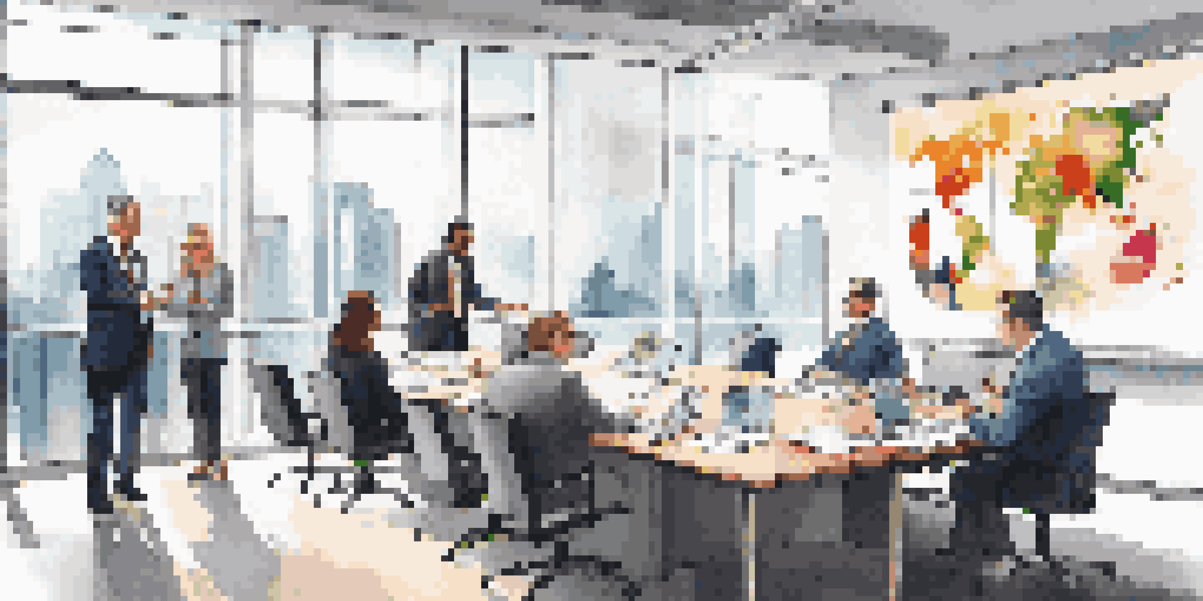 A diverse group of business analysts in a modern office environment, reviewing financial graphs on a projector screen.