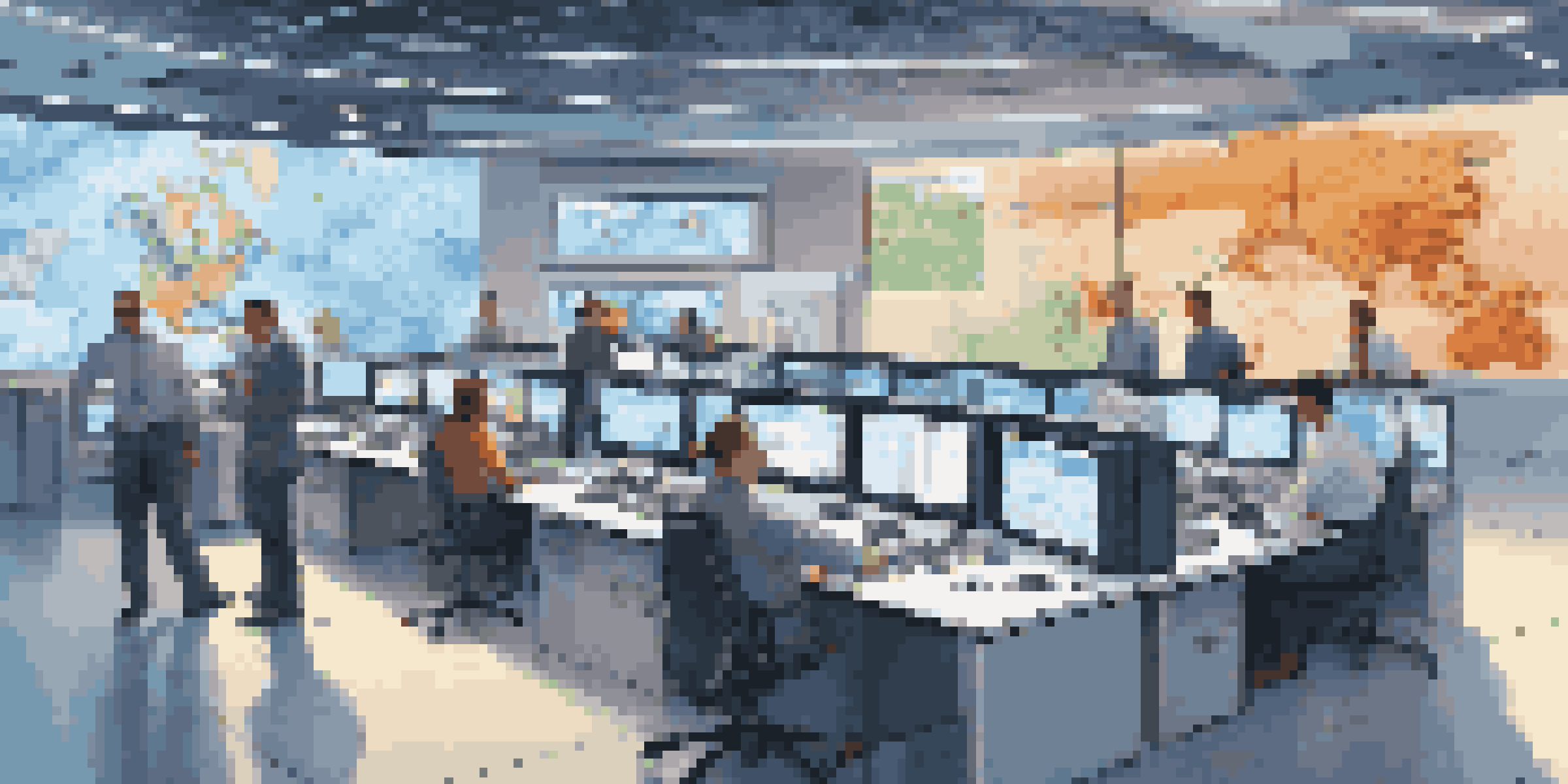 A busy telecommunications control room with professionals working together, featuring large screens and modern technology.