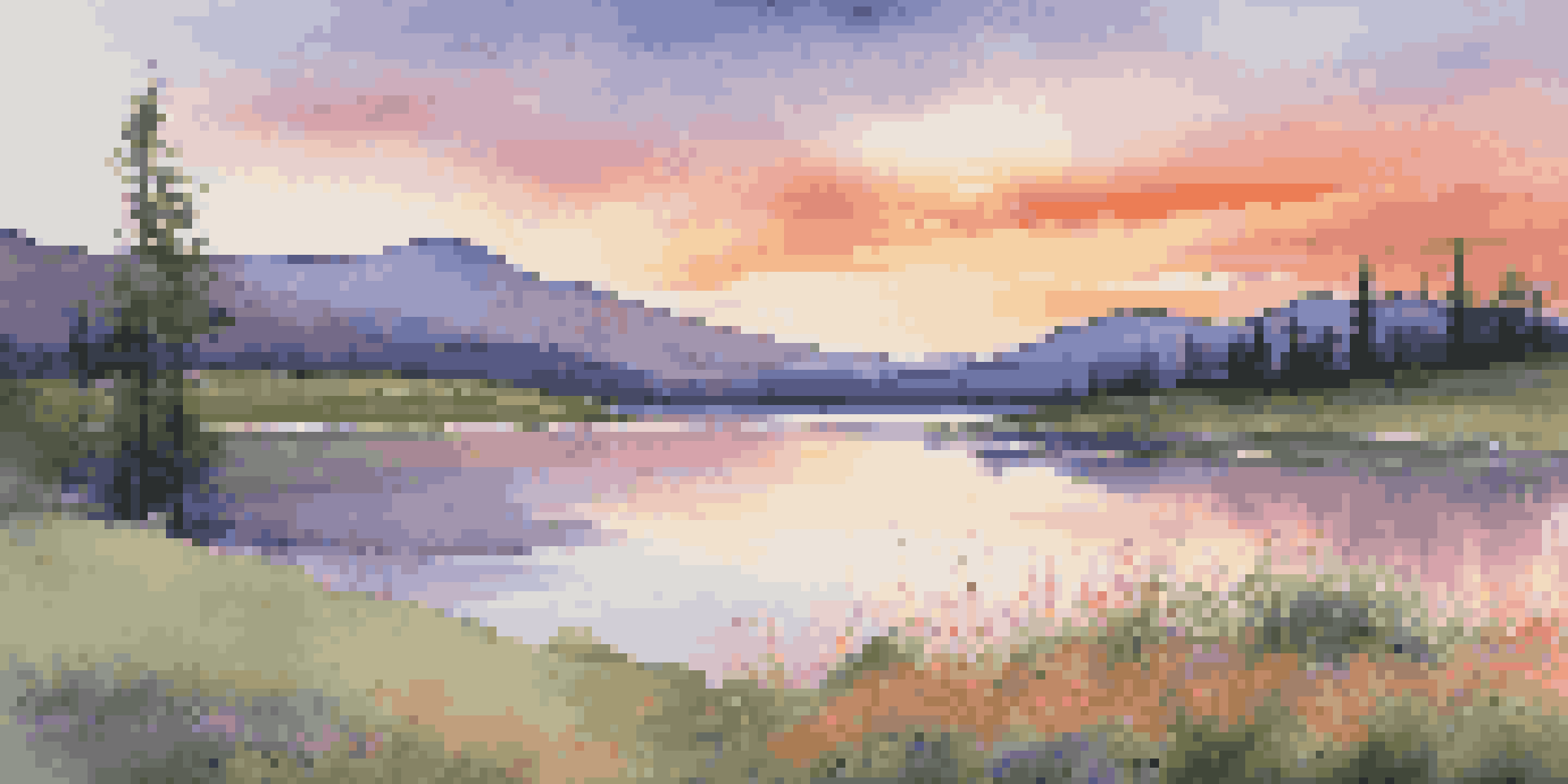 A beautiful sunset over a calm lake with vibrant reflections in the water, surrounded by green grass and wildflowers, set against distant mountains.