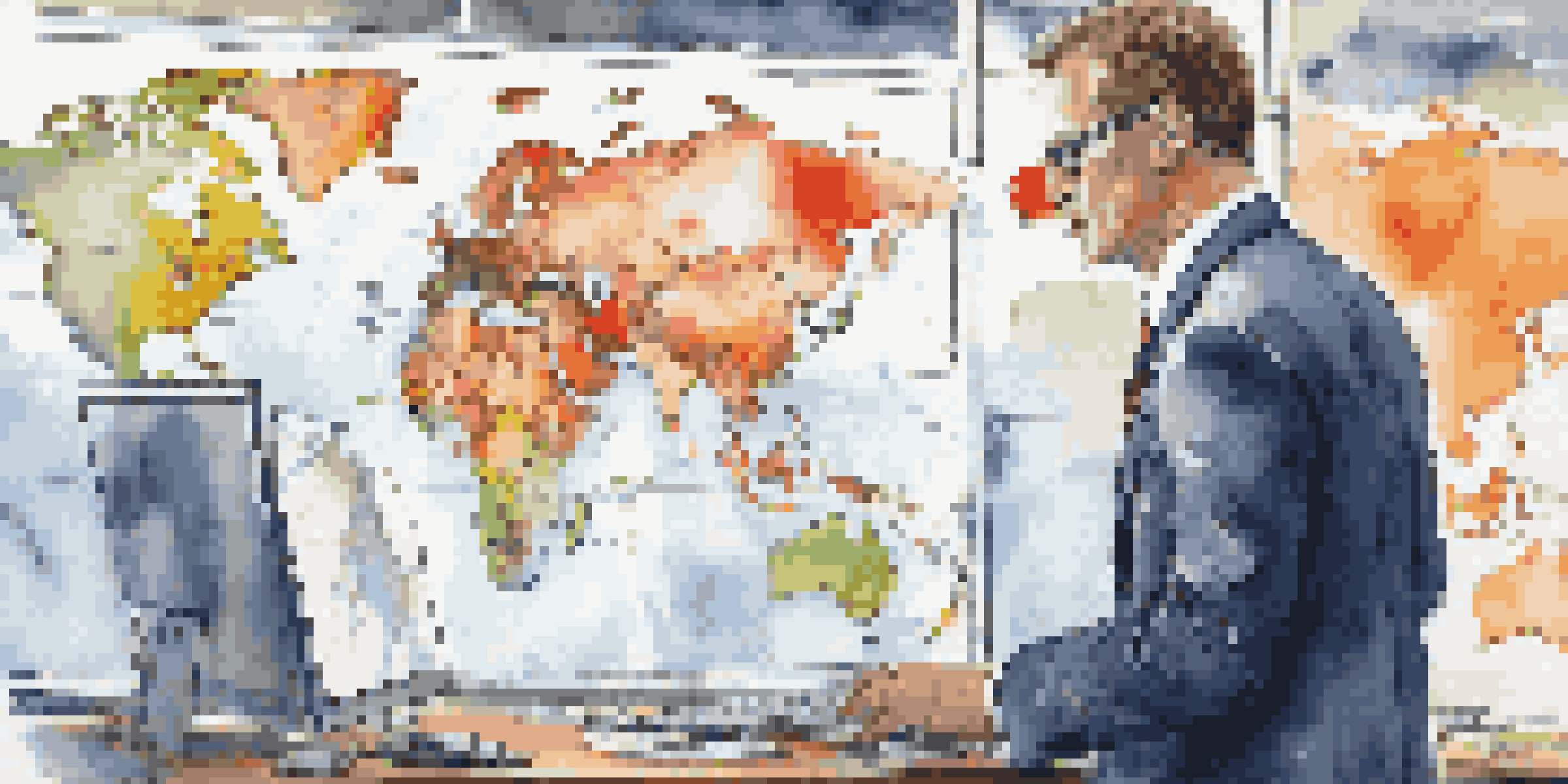 A businessman analyzing international market trends in a modern office with a world map in the background.