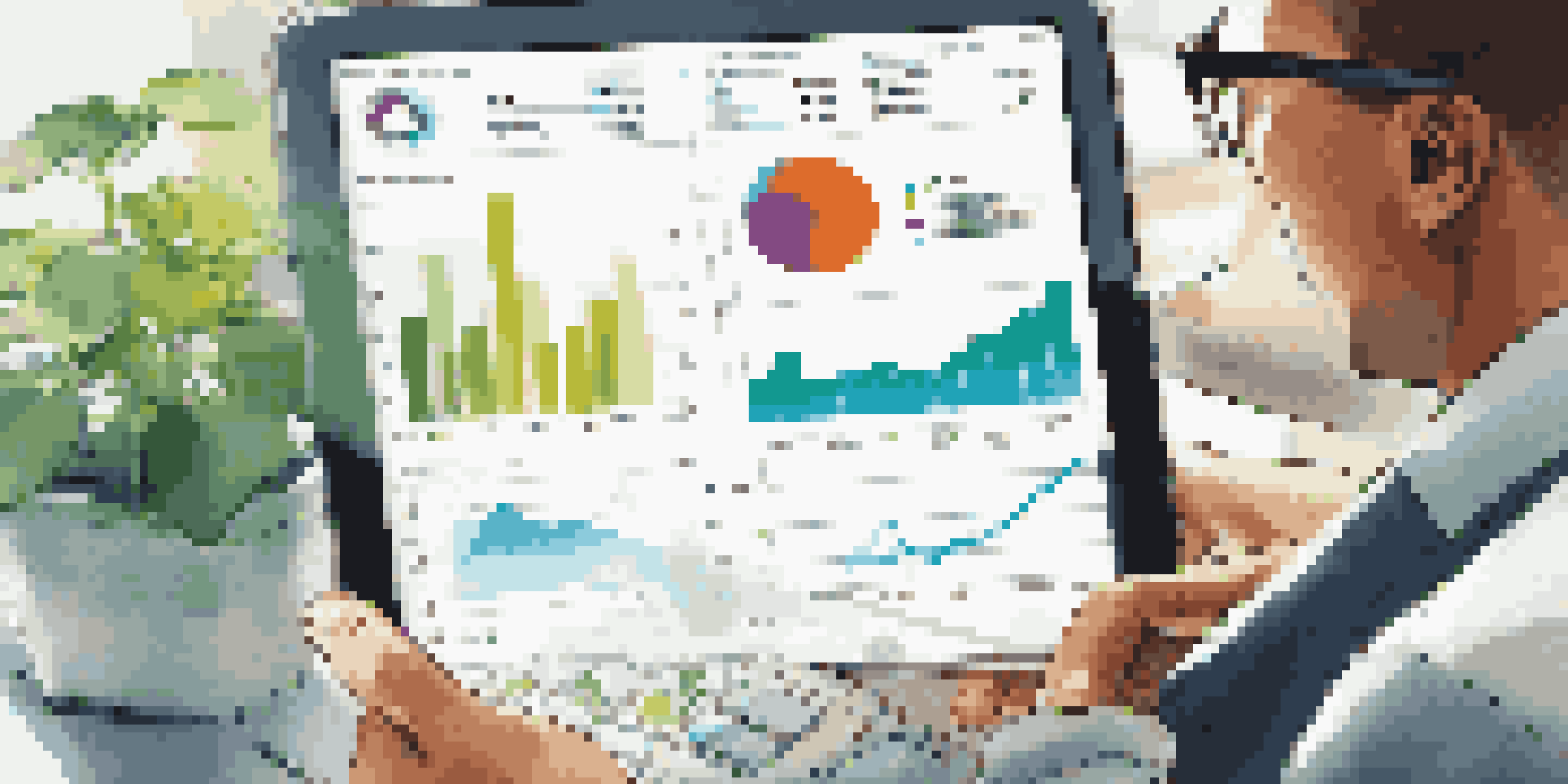 A financial analyst examining graphs and charts on a tablet in a bright office environment with a plant in the background.