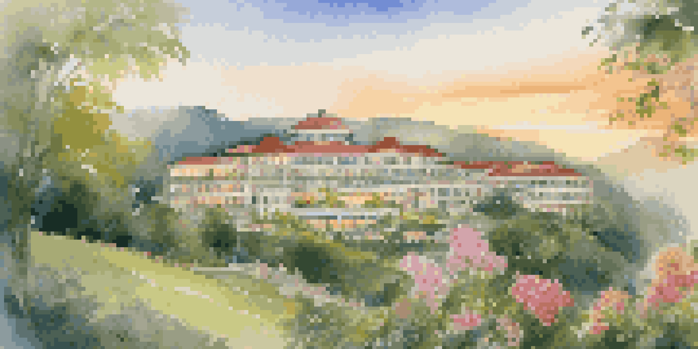 A luxurious hotel on a hillside, surrounded by greenery and flowers, illuminated by sunrise.