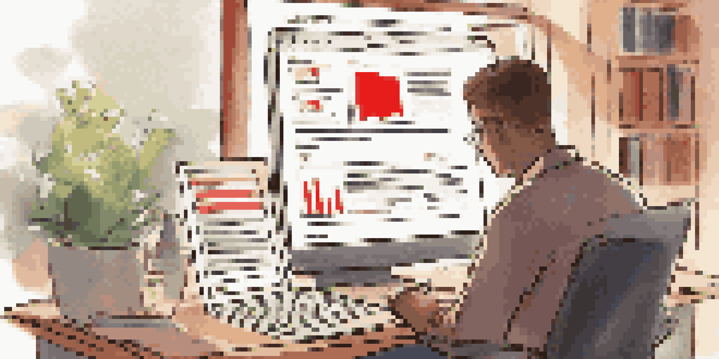 A person closely examining online investment reviews on a laptop in a cozy workspace, with financial books and notes around.