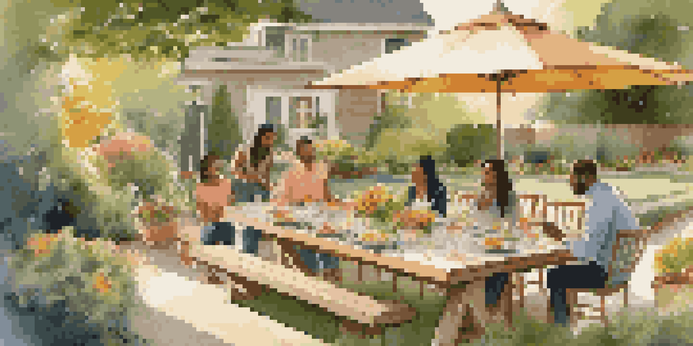 A family enjoying dinner in a well-kept backyard filled with greenery and flowers during golden hour.