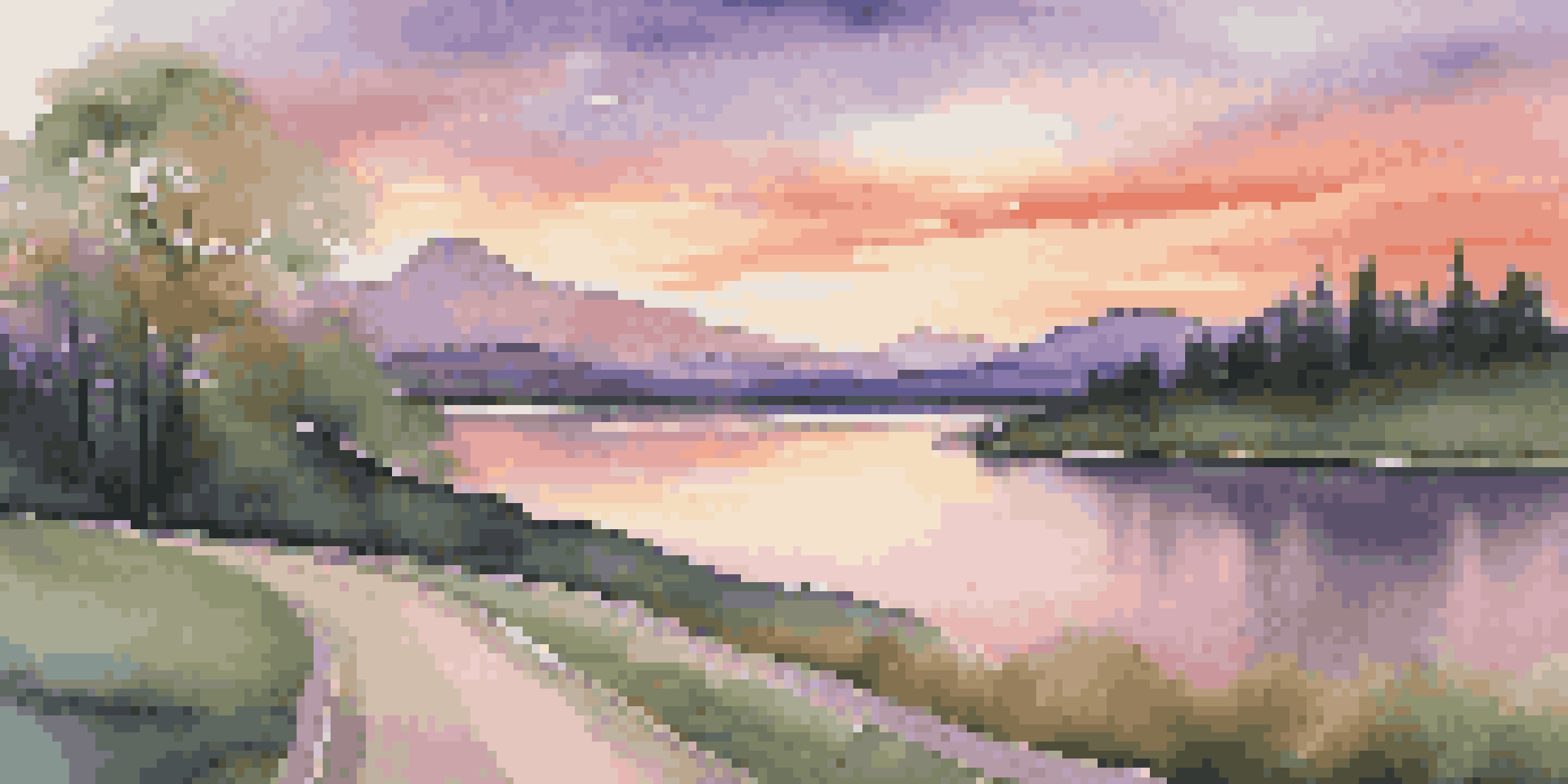A picturesque scene of a winding road leading to mountains at sunset, with a calm lake in the foreground and lush trees lining the road.