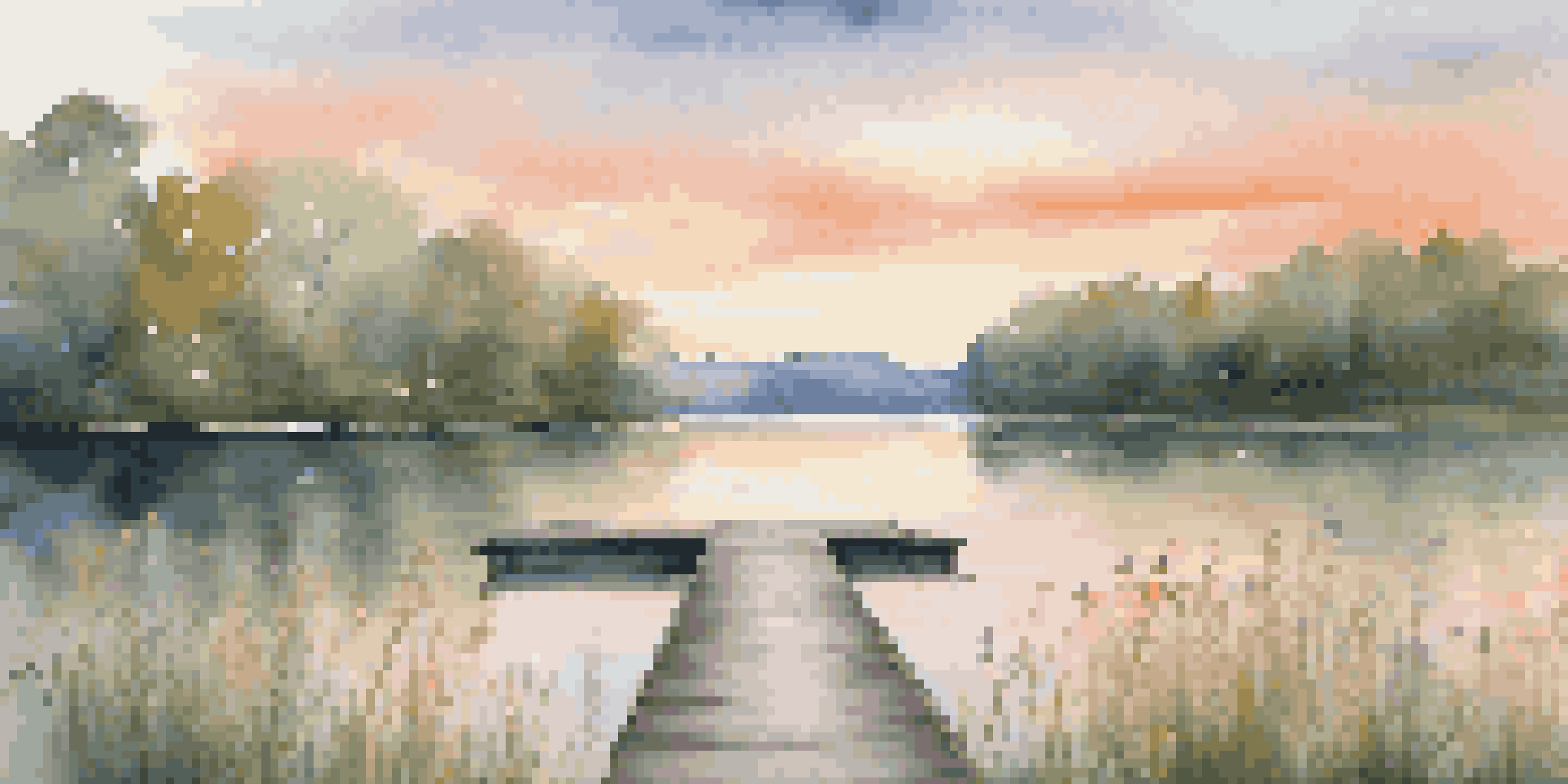 A calm lakeside scene at sunset with a wooden dock and colorful reflections in the water.