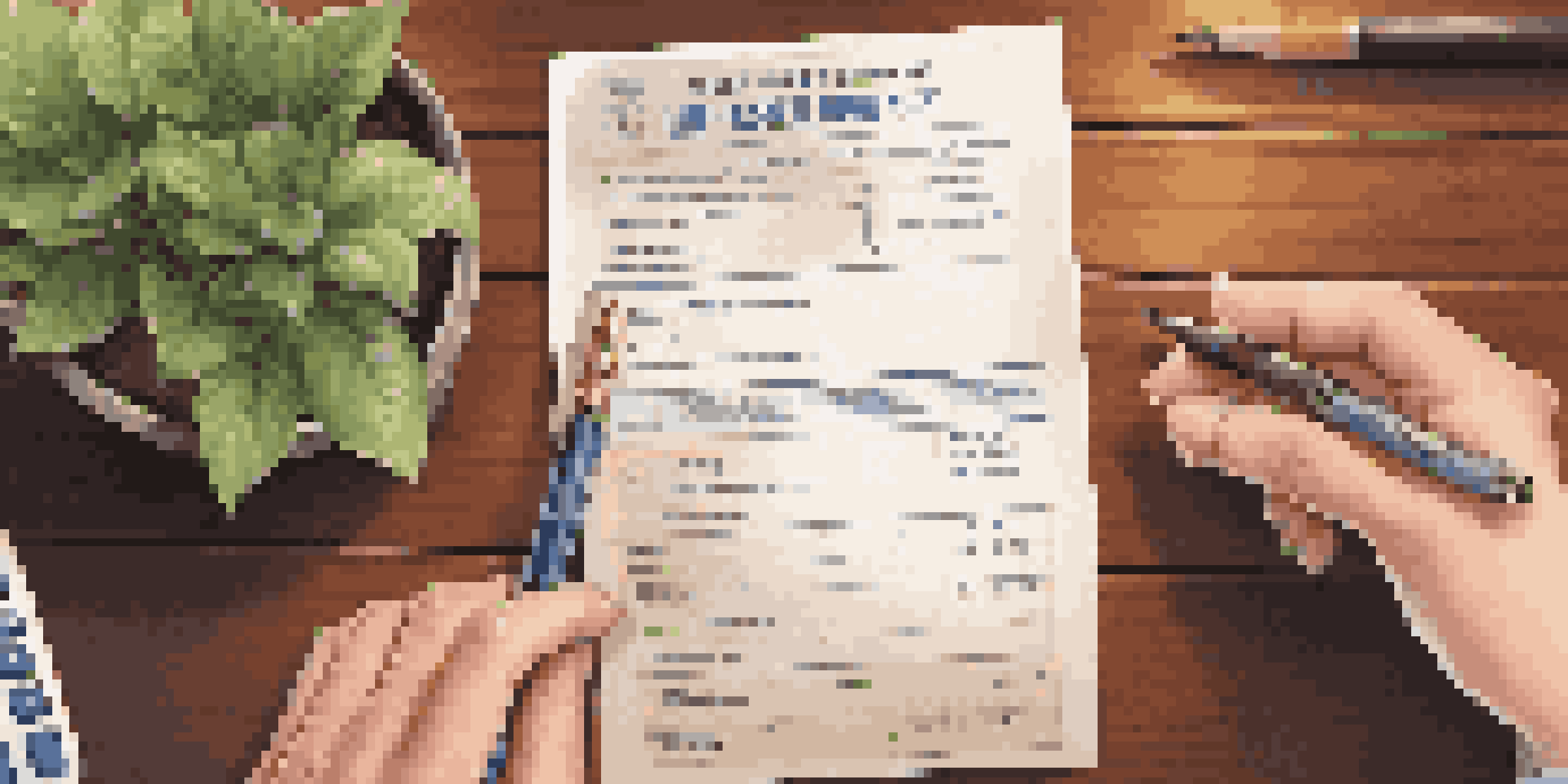 A hand holding a whole life insurance policy document with a calculator and pen on a wooden table, under warm lighting.