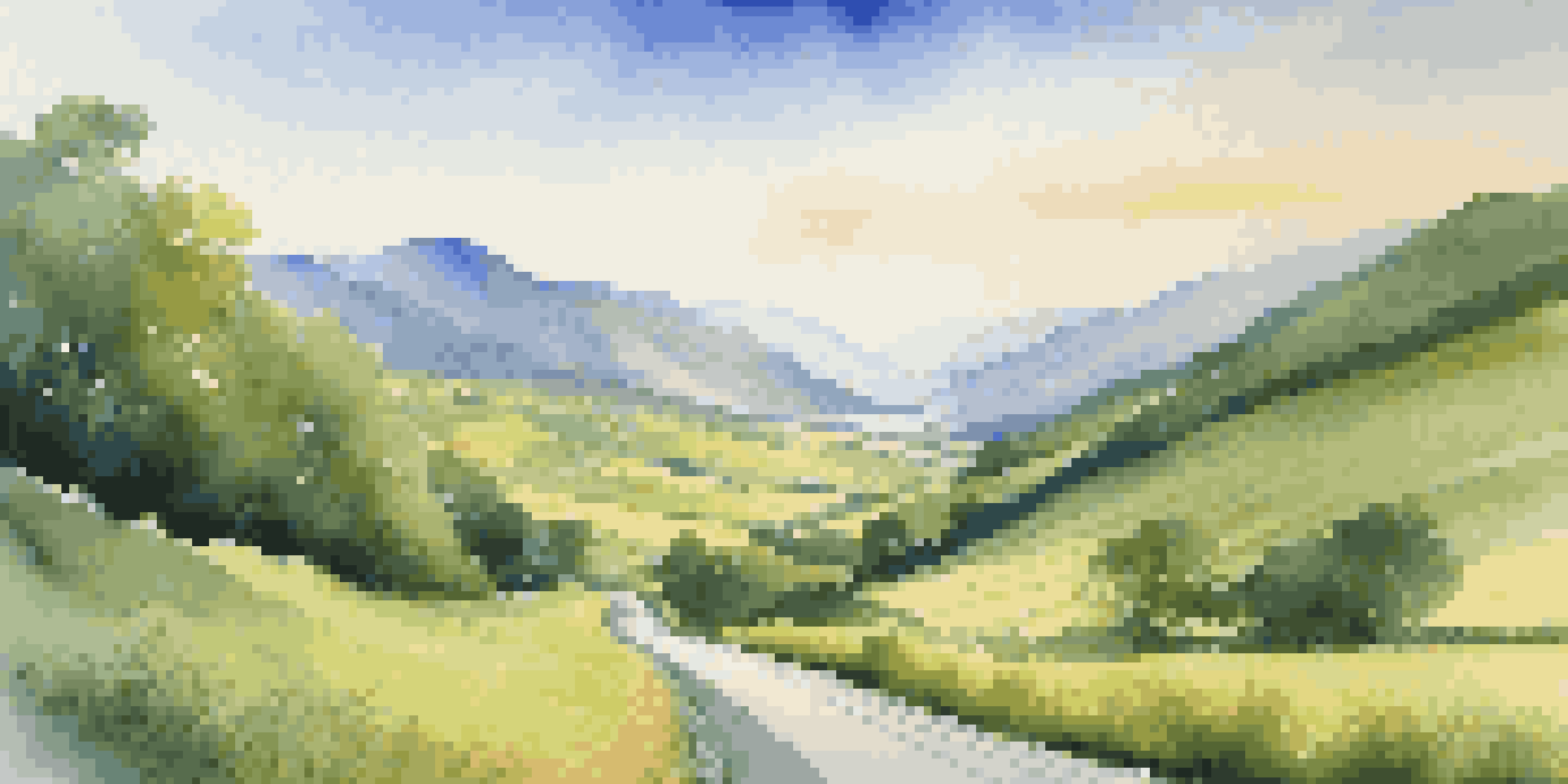 A long winding road through a green valley with mountains in the background under a blue sky, symbolizing a long journey.