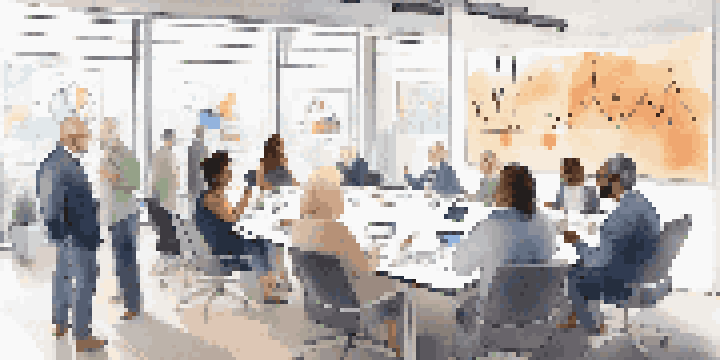 A diverse group of individuals discussing investment strategies in a bright, modern conference room.