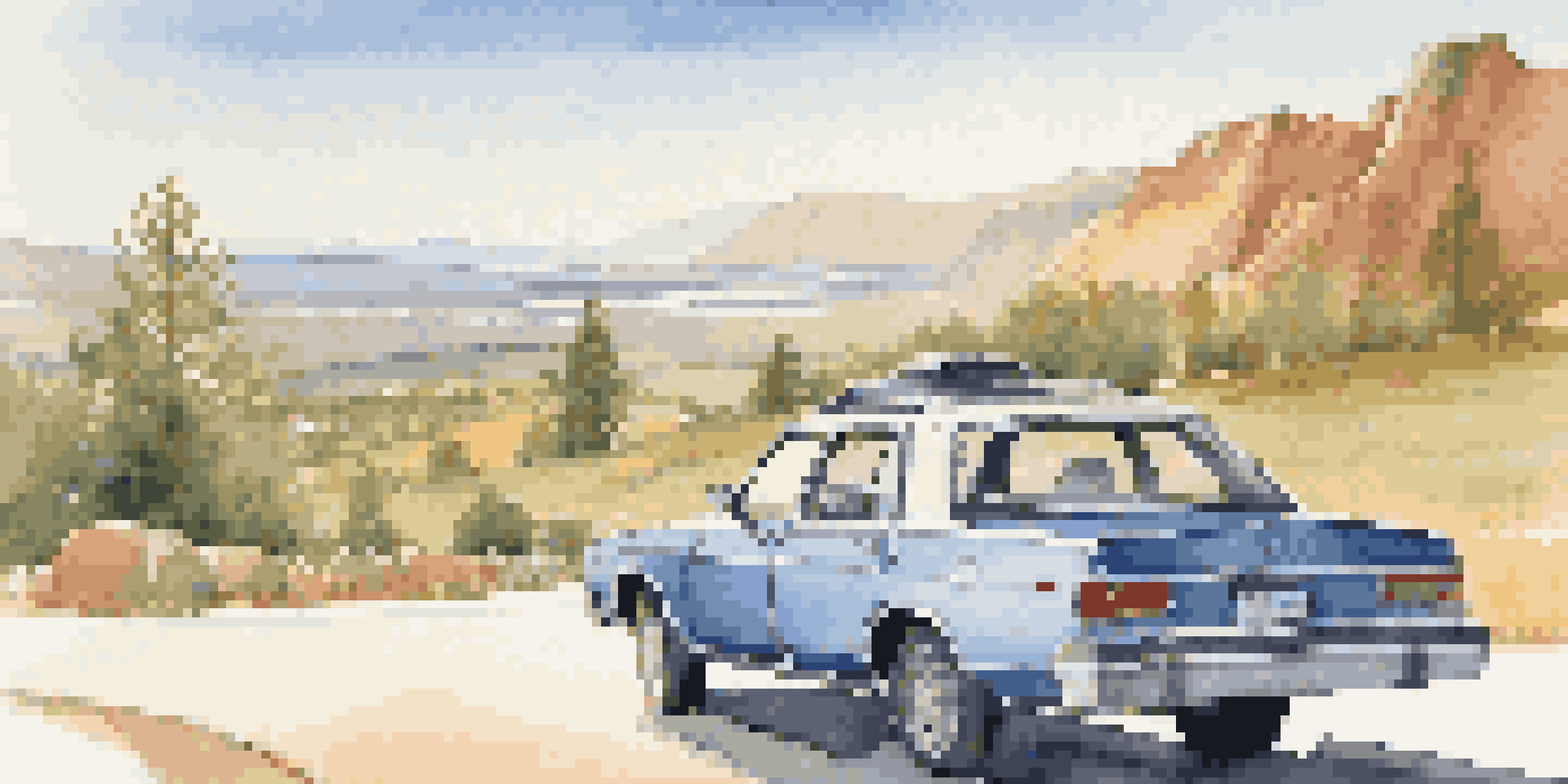 A parked car on a scenic overlook with mountains and a clear sky, showcasing a travel map on the hood.