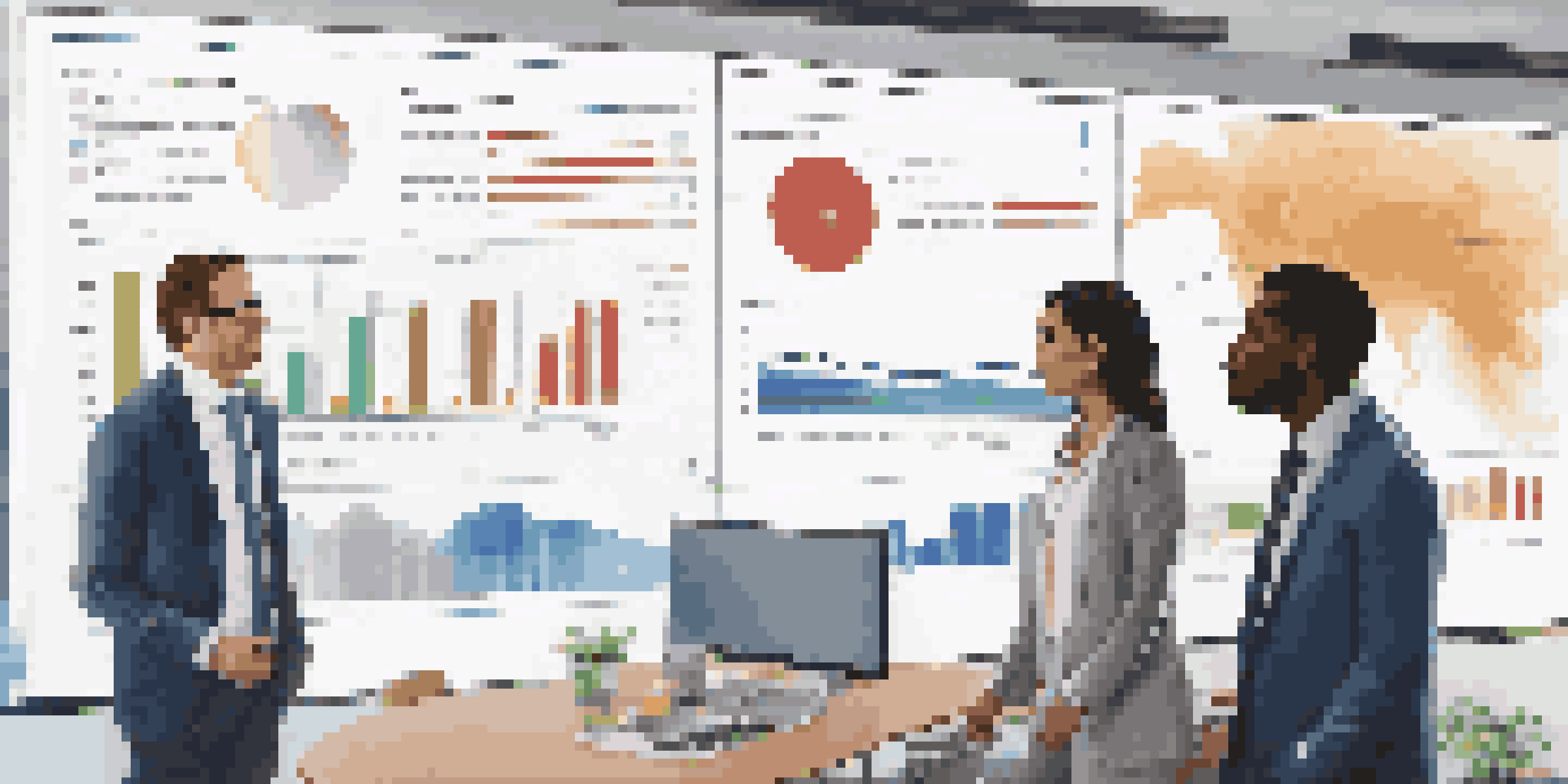 A diverse team of three professionals discussing a colorful financial roadmap displayed on a large screen in a modern office with natural light.