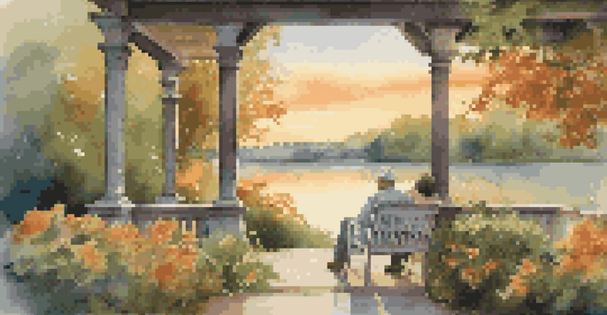 A couple relaxing on a porch during sunset, overlooking a calm lake with greenery and flowers around them.