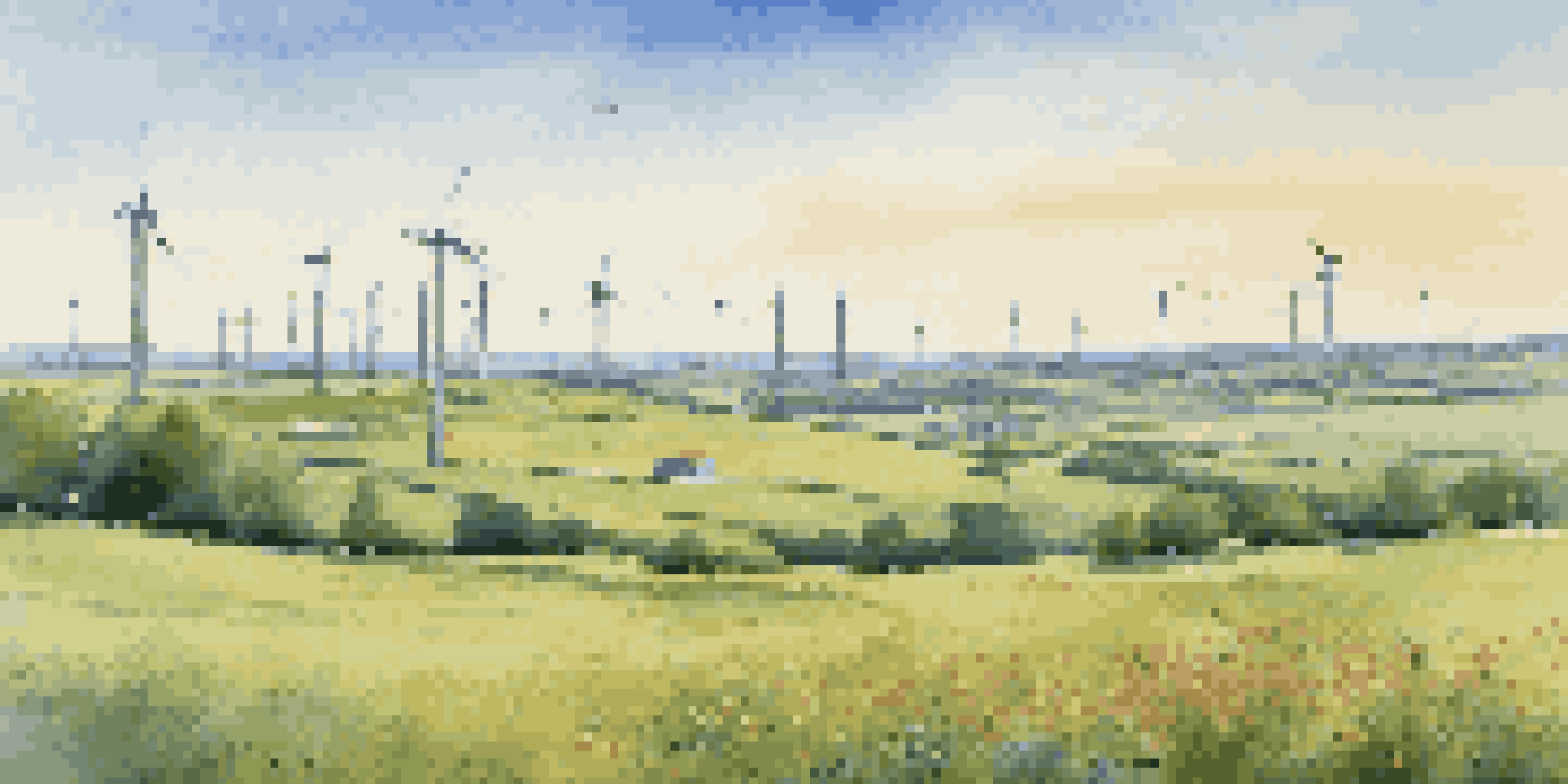 A peaceful scene featuring a wind farm with turbines and a green field of wildflowers, representing the integration of renewable energy and community.