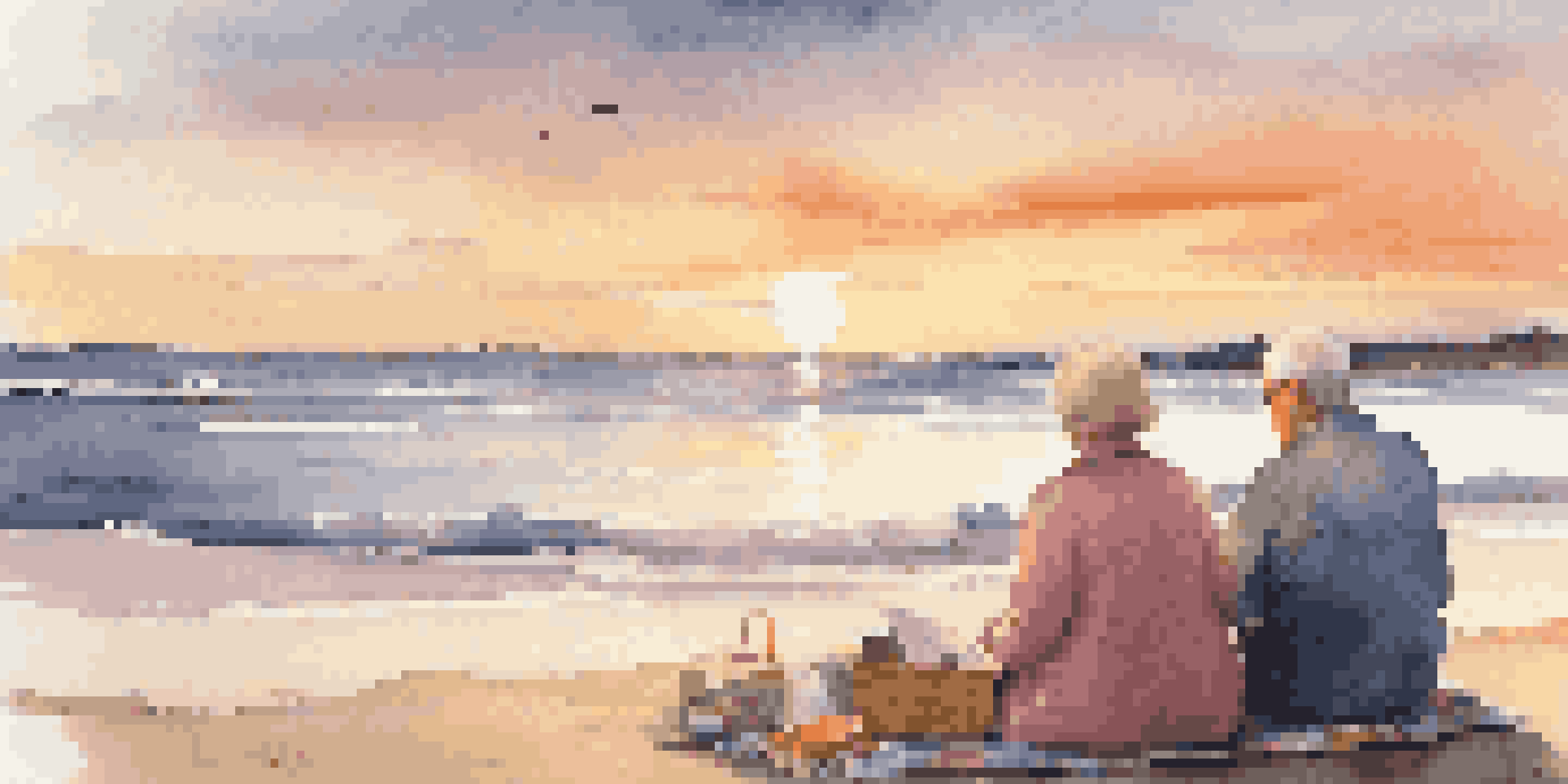 A retired couple sitting on a beach at sunset, enjoying their time together with a picnic setup.