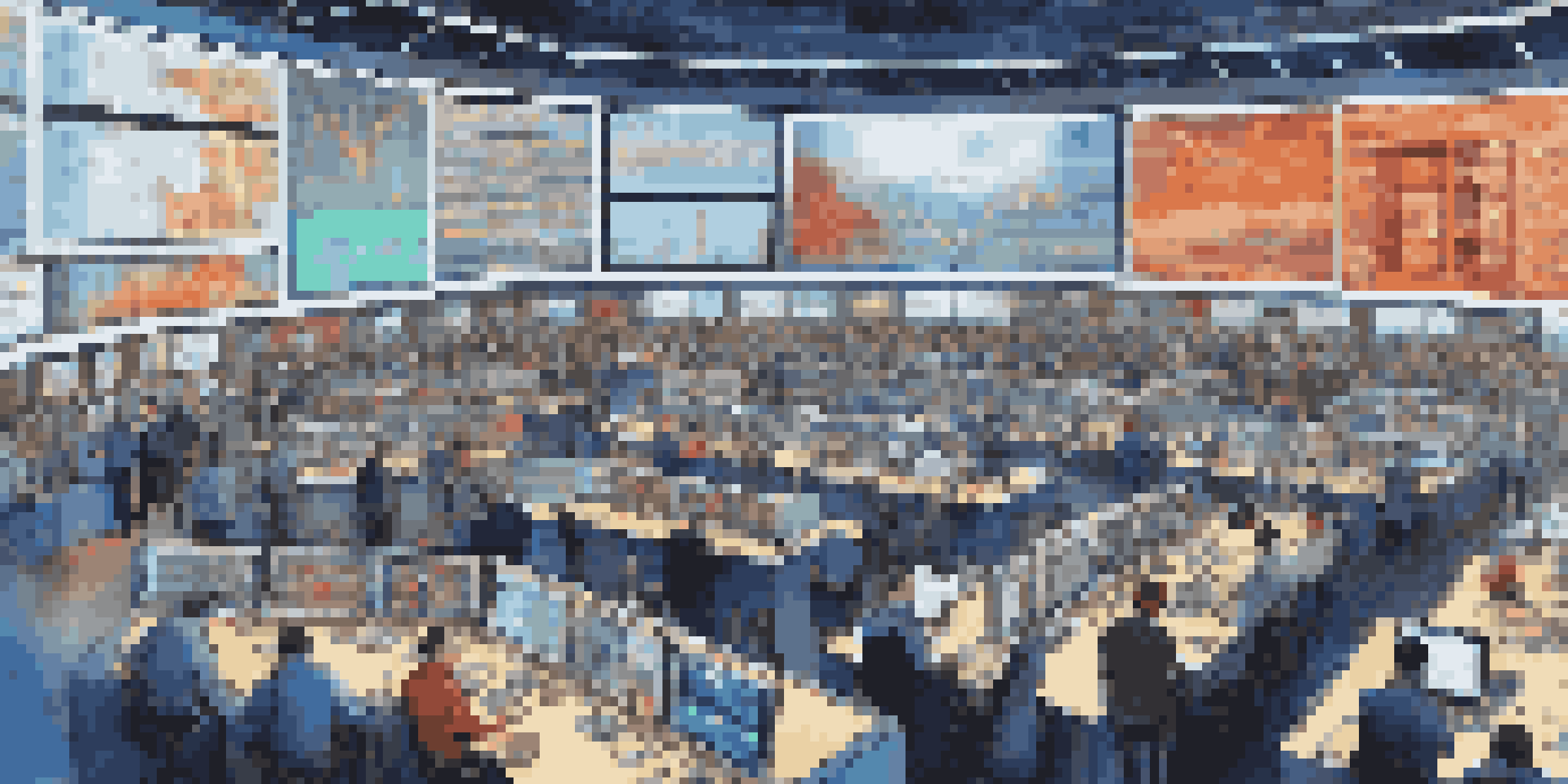 A busy stock trading floor with traders looking at screens and digital displays showing stock prices.