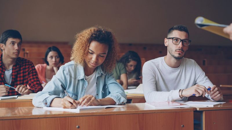 University students taking notes during a lecture