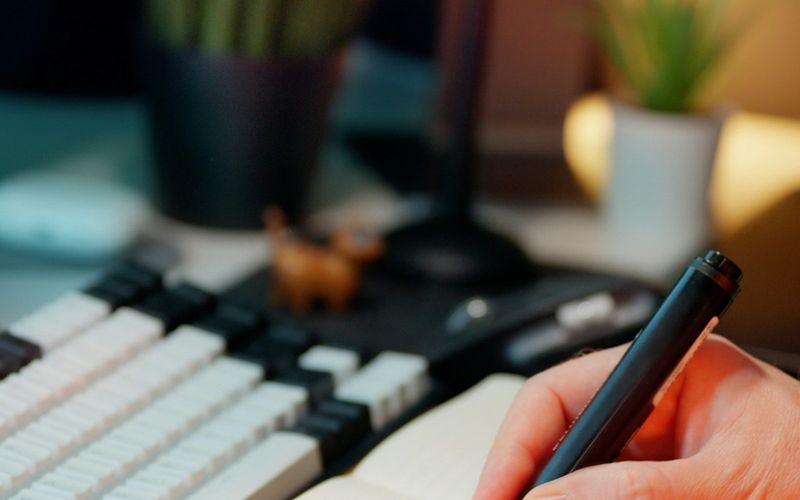 Hand writing in a notebook with checkboxes