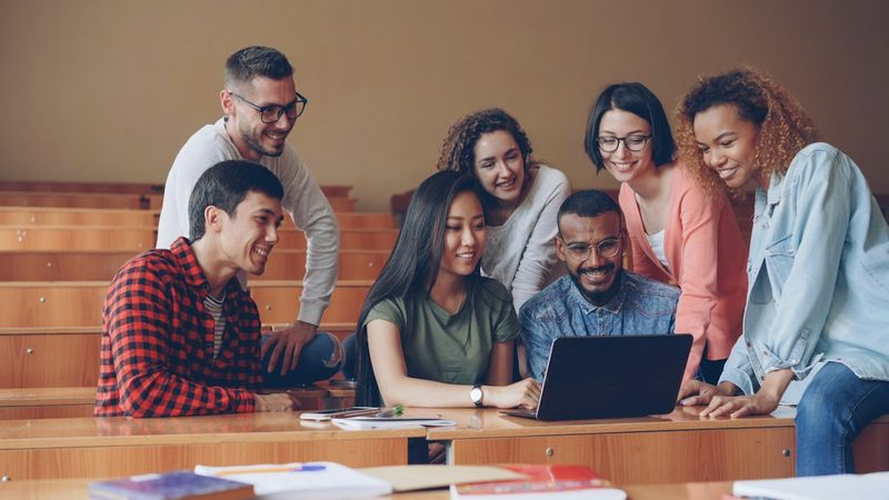 College students working together around a laptop