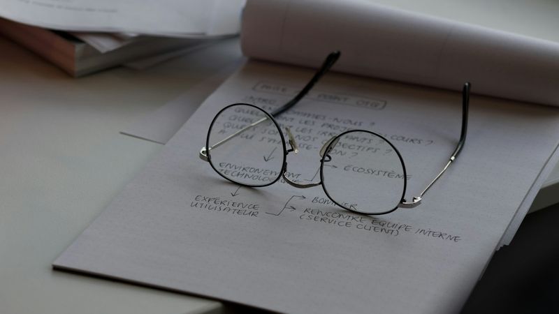 Eyeglasses resting on printed documents