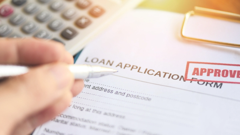Loan application form with a red APPROVED stamp.