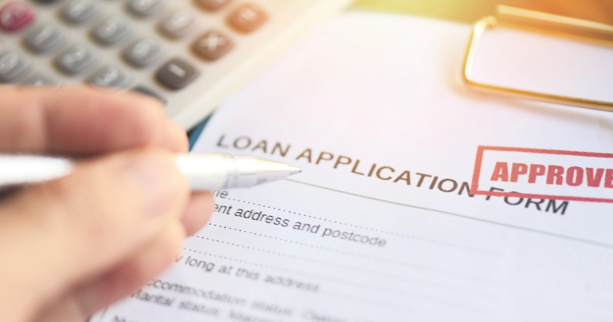 Loan application form with a red APPROVED stamp.