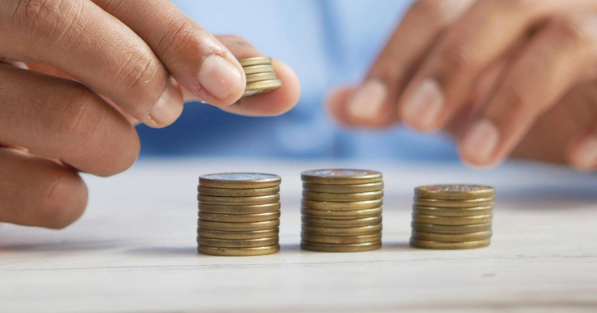 Hands placing coins in 3 piles