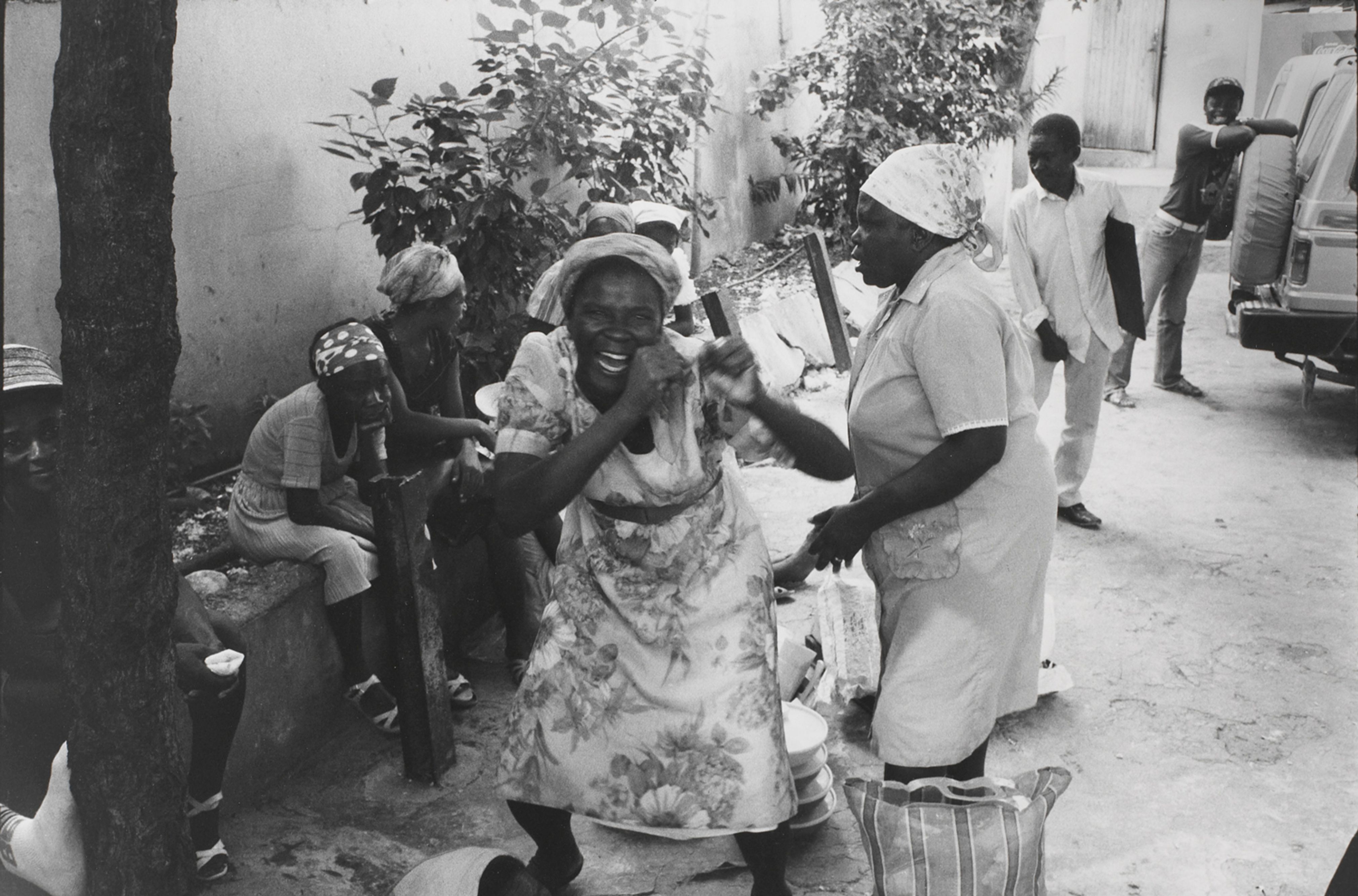 Women that sell food outside the Copa Club reenact the attacks upon the Tontons Macoute