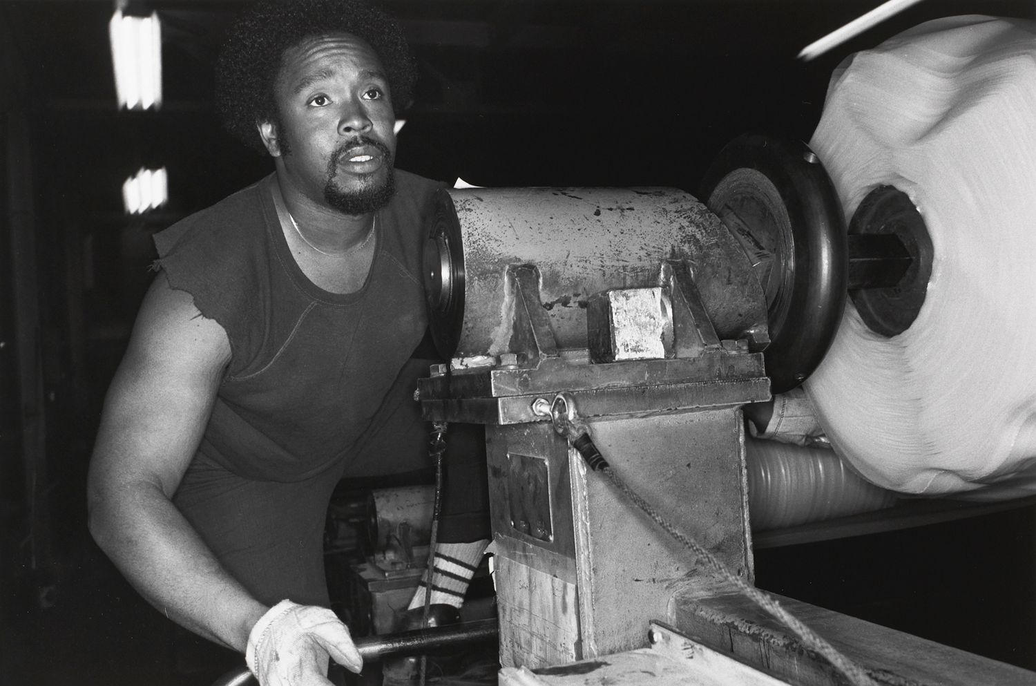 AKRON, OHIO (man leaning over machine)