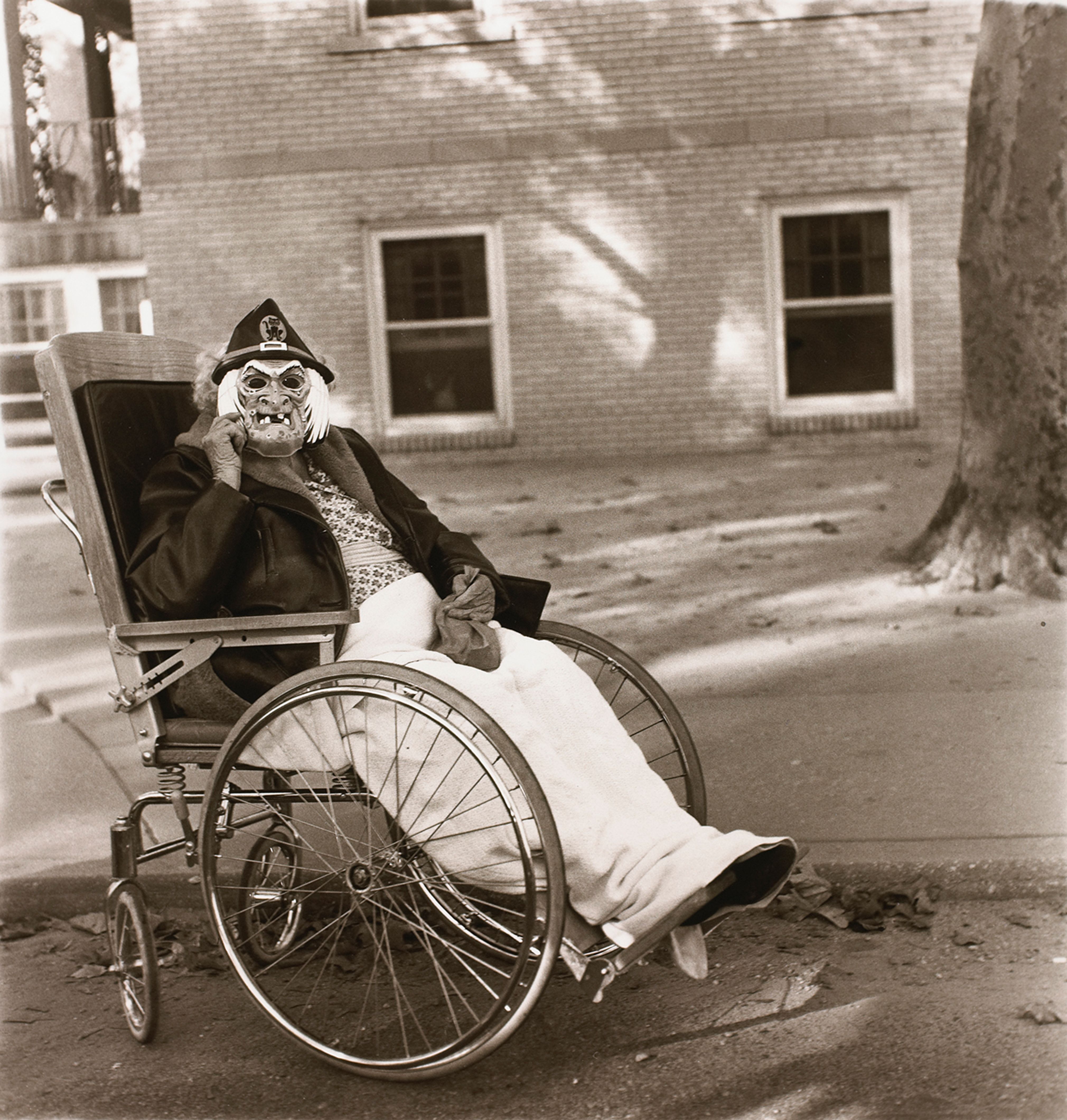 Masked woman in a wheelchair, Pa.