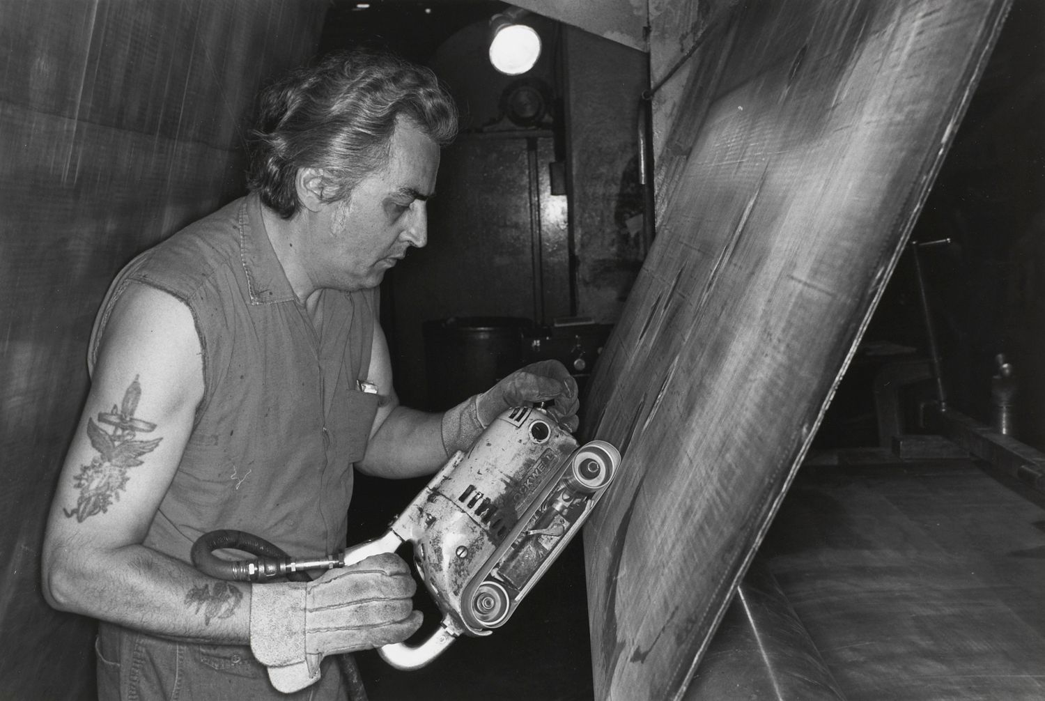 AKRON, OHIO (man sanding)
