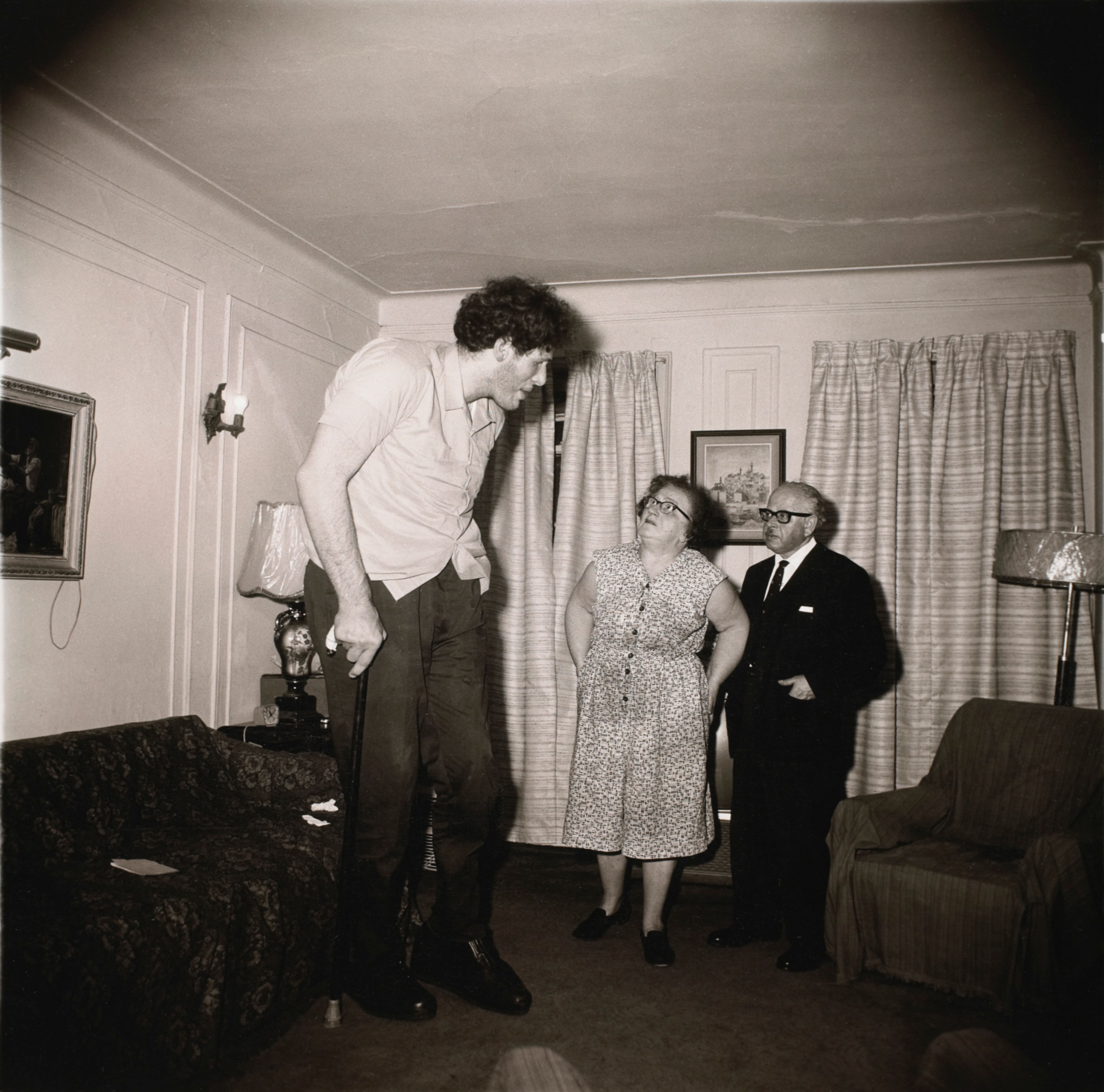 A Jewish giant at home with his parents in the Bronx, N.Y.