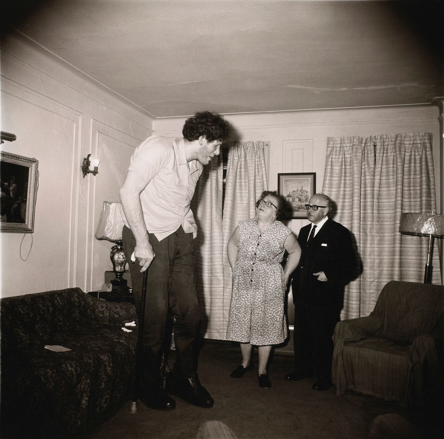 A Jewish giant at home with his parents in the Bronx, N.Y.