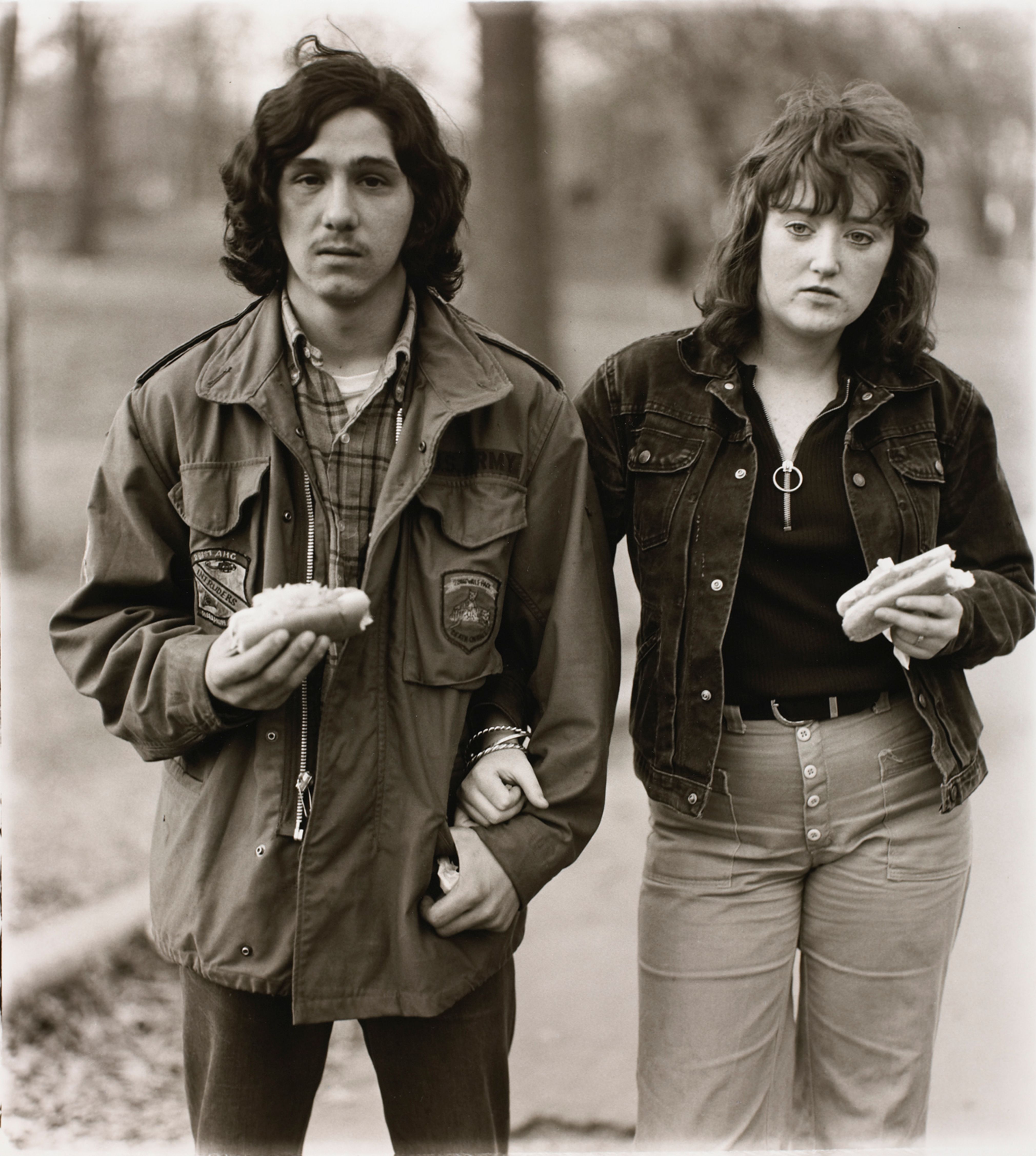 A young man and his girlfriend with hot dogs in the park, N.Y.C.